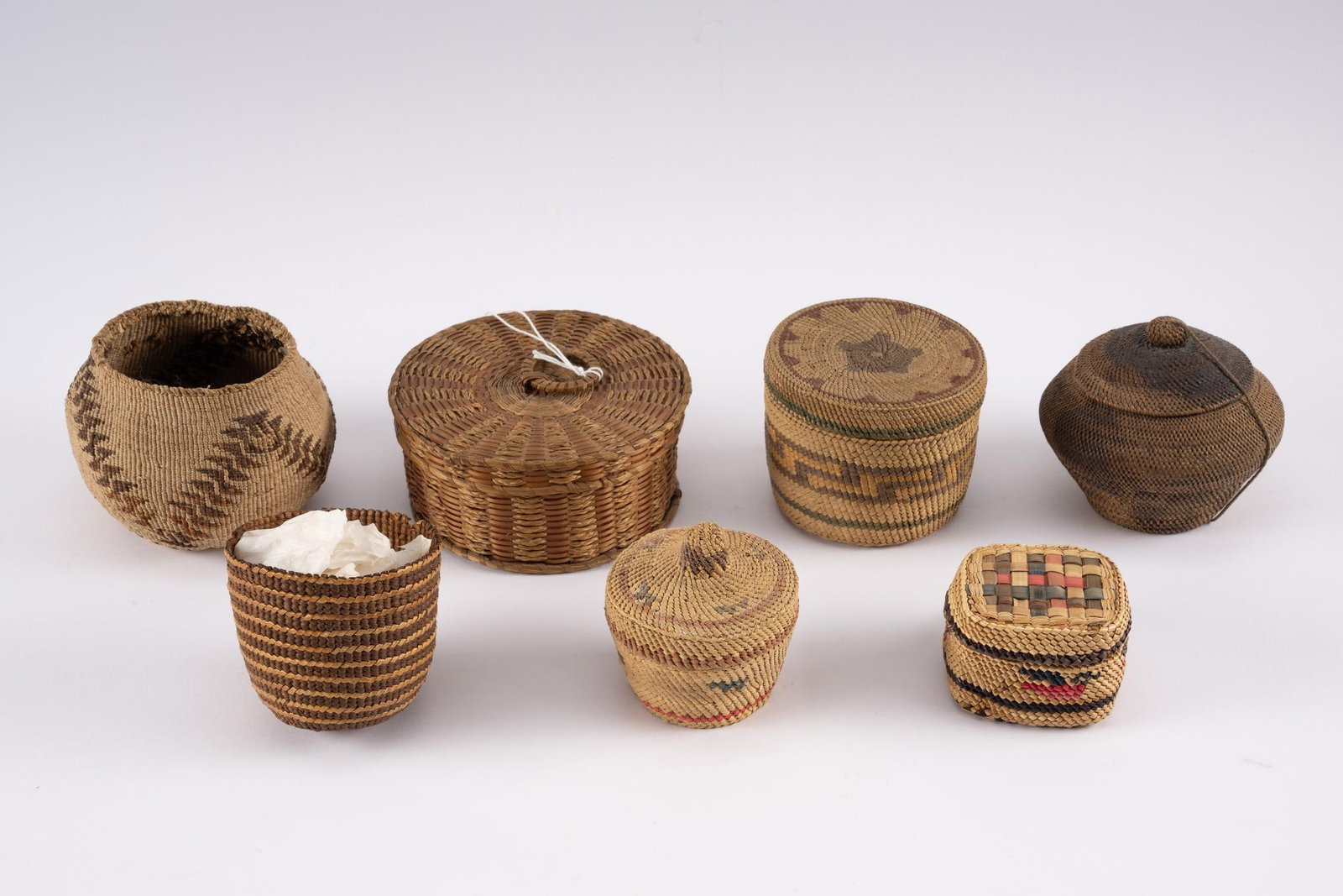 Seven California and Southwest Tribal Baskets: A group of seven Southwestern and California tribal baskets. Most dating circa 1920-1950. Measurements: 2-1/2" to 5". Condition: Overall damage to rims.