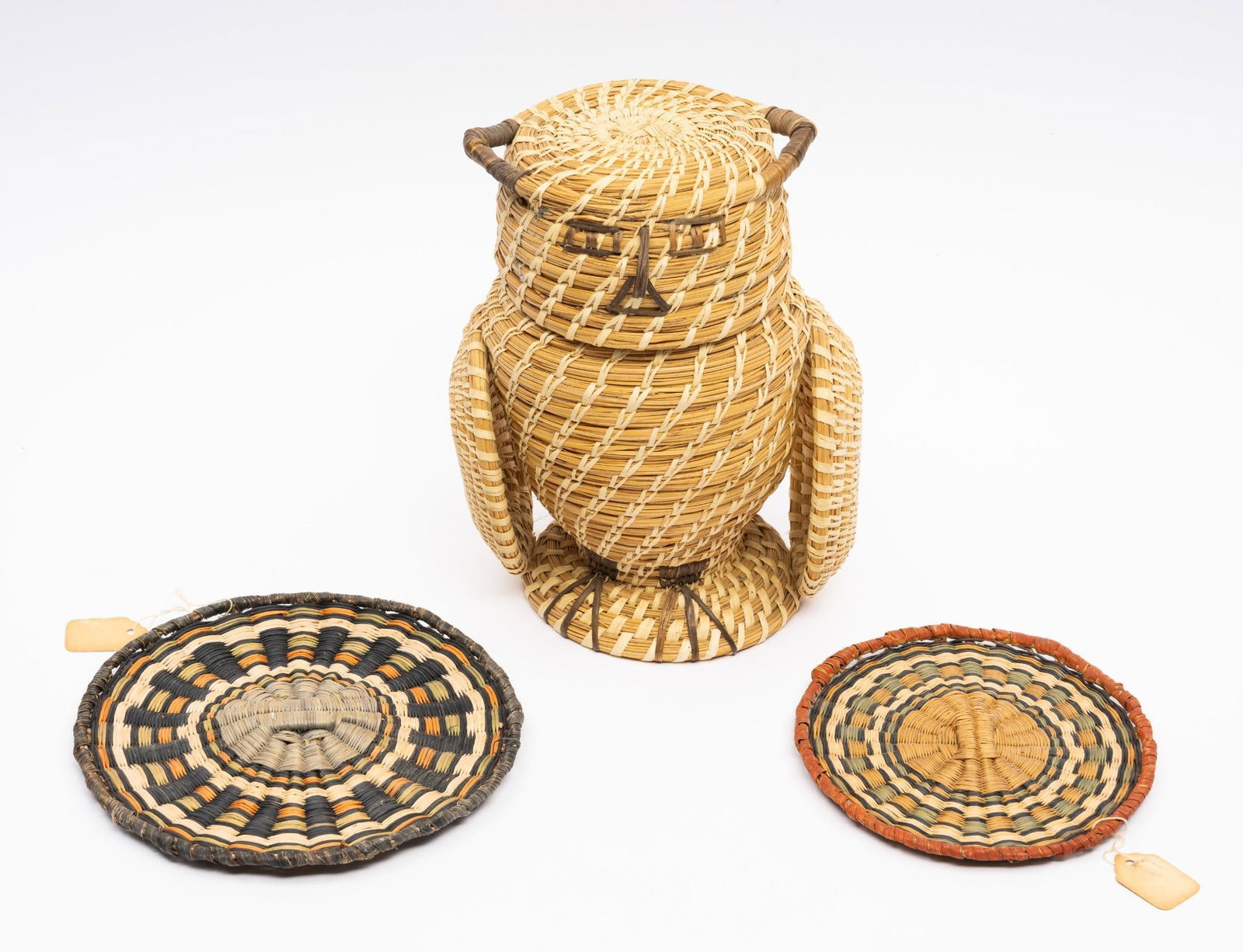 Papago Owl Container and Two Hopi Woven Plaques: A classic woven Papago two-piece owl probably fourth quarter of the 20th century along with two finely woven Hopi plaques probably early to mid 20th century. Measurement: Owl -- 8-3/4" tall ; plaques 