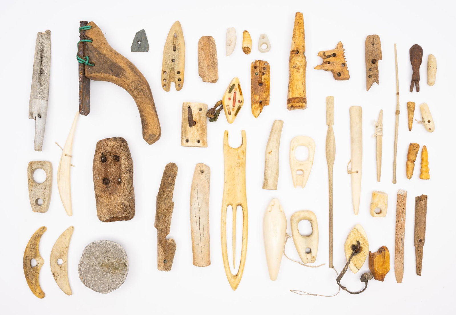 35 Arctic Tribal Tools: A group of thirty five Arctic tribal tools dating from the early 20th century including hooks, fishing net mending tools, needles and awls. Measurements: 1" to 8-1/2". Condition: Overall good.