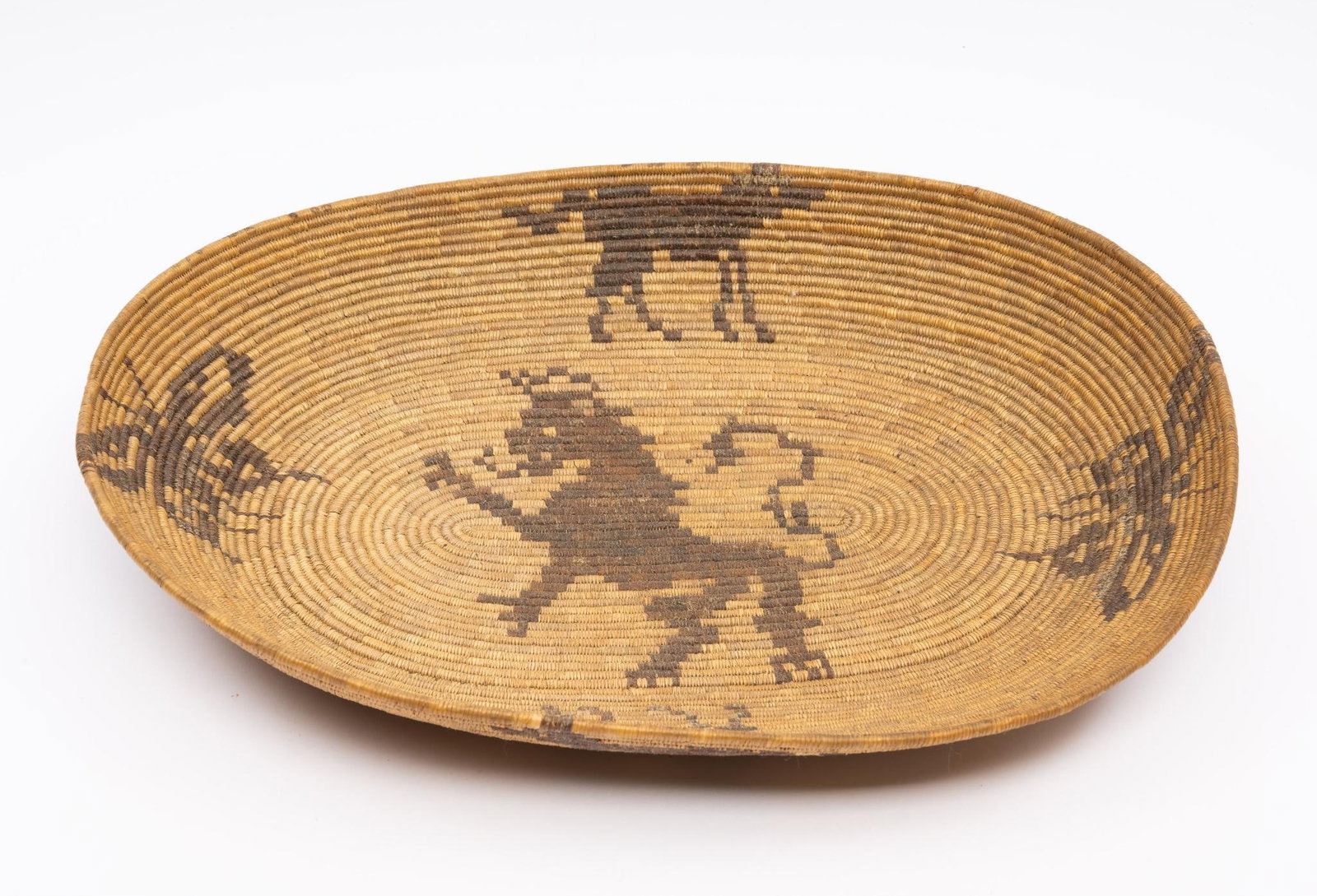 Mission Style Woven Basket: An unusual mission style woven basket incorporating the rampant lion of the English royal arms along with other natural motifs. Probably Canadian in origin. Early 20th century for the tourist trade. M