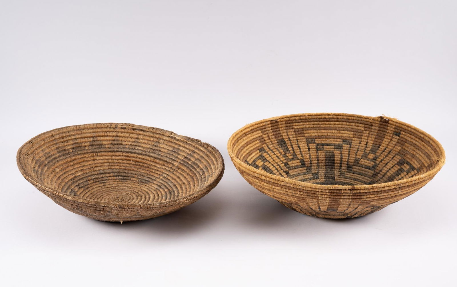 Navajo Wedding Basket and Pima Basket: Two classic baskets by two of the finest basket-making communities. The first a very fine early 20th century Navajo wedding basket. While called wedding baskets, they served a wide number of secular a