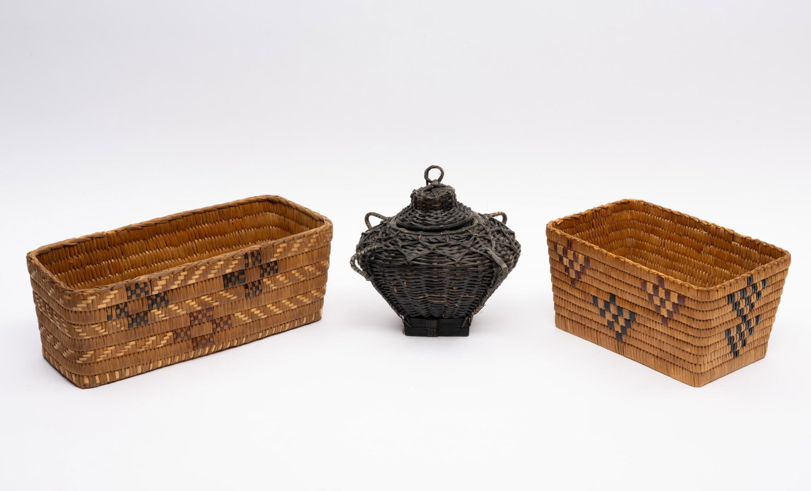 Two Rectangular Papago Letter Baskets and Painted Basket: Two rectangular Papago woven letter boxes and a round black painted box of unusual form. Measurement: 9-3/4" to 14" diameter. Condition: Overall good. Note: black one has potpourri inside.