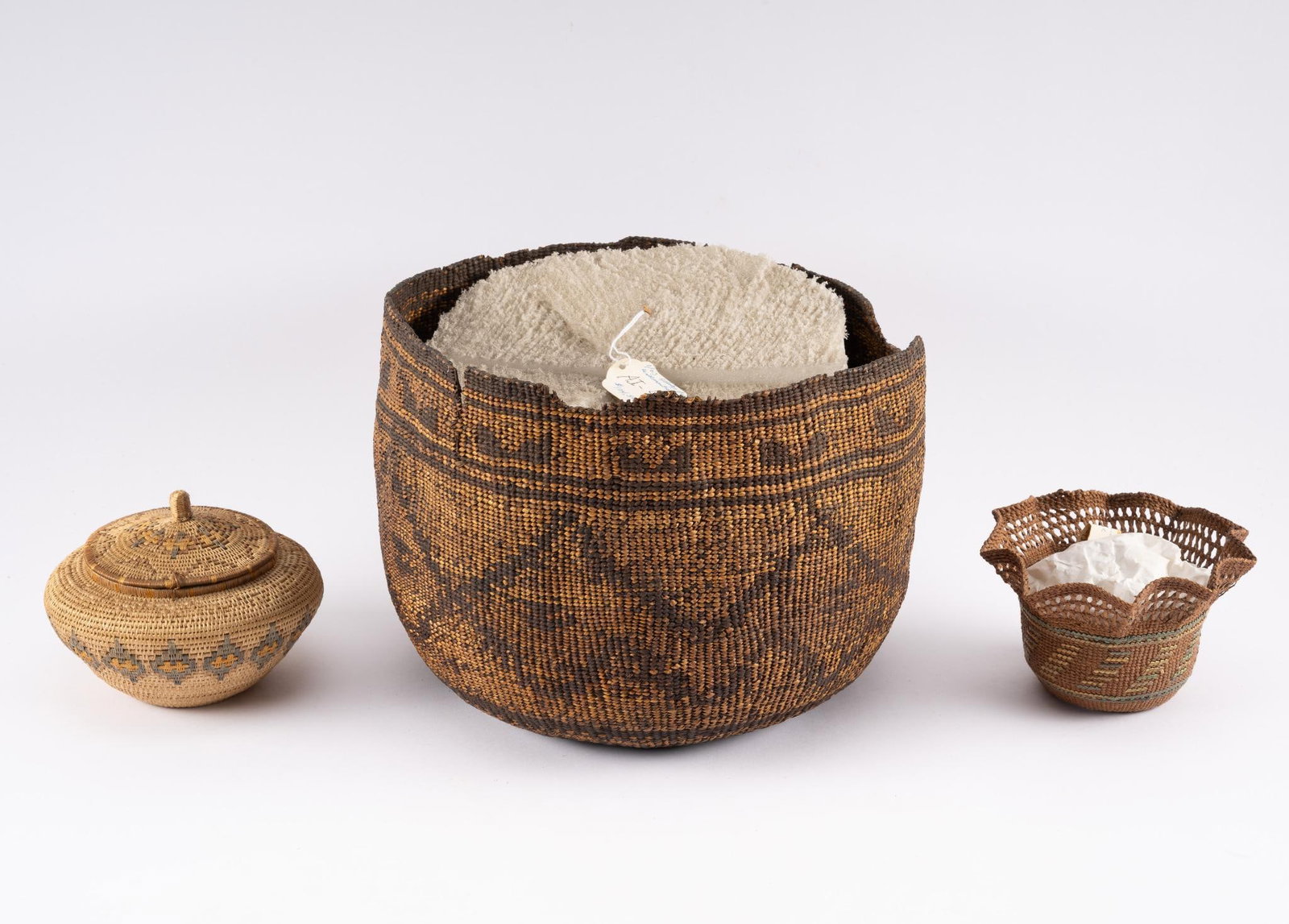 Group of 3 Apache and Pomo Baskets: NOT ELIGIBLE FOR IN-HOUSE SHIPPING. A group of three Native American baskets with damages. Pomo and probably Apache. Measurement: 6" to 11" diameter. Condition: Large one is beginning to fall apart, b