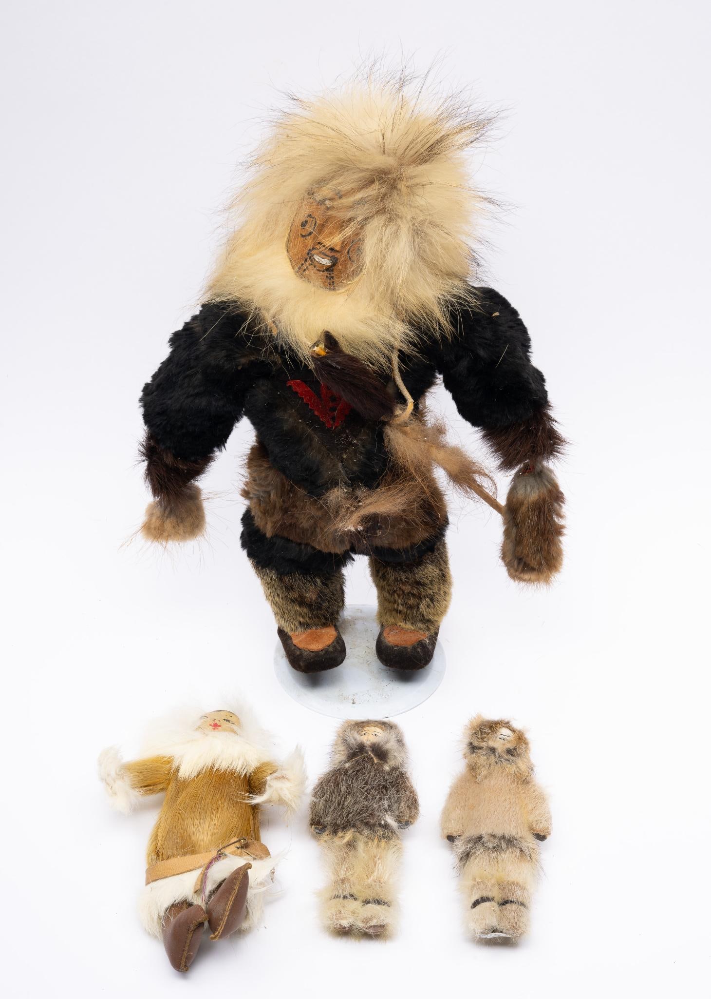 Four Arctic Tribal Dolls: Four hide and fur Arctic tribal-made, probably Inuit, dolls. Measurements: 6-1/2" to 16". Condition: Overall good with some spots losing fur.