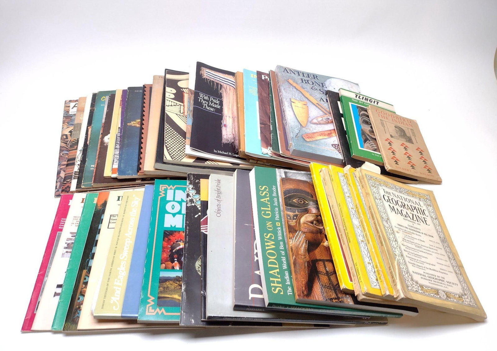 50 American Indian Magazines, Booklets, and Ephemera: NOT ELIGIBLE FOR IN-HOUSE SHIPPING. Includes Indian Artifact Society magazines, National Geographic magazines, booklets on Navajo rugs, maps, and more. Condition: Overall good.