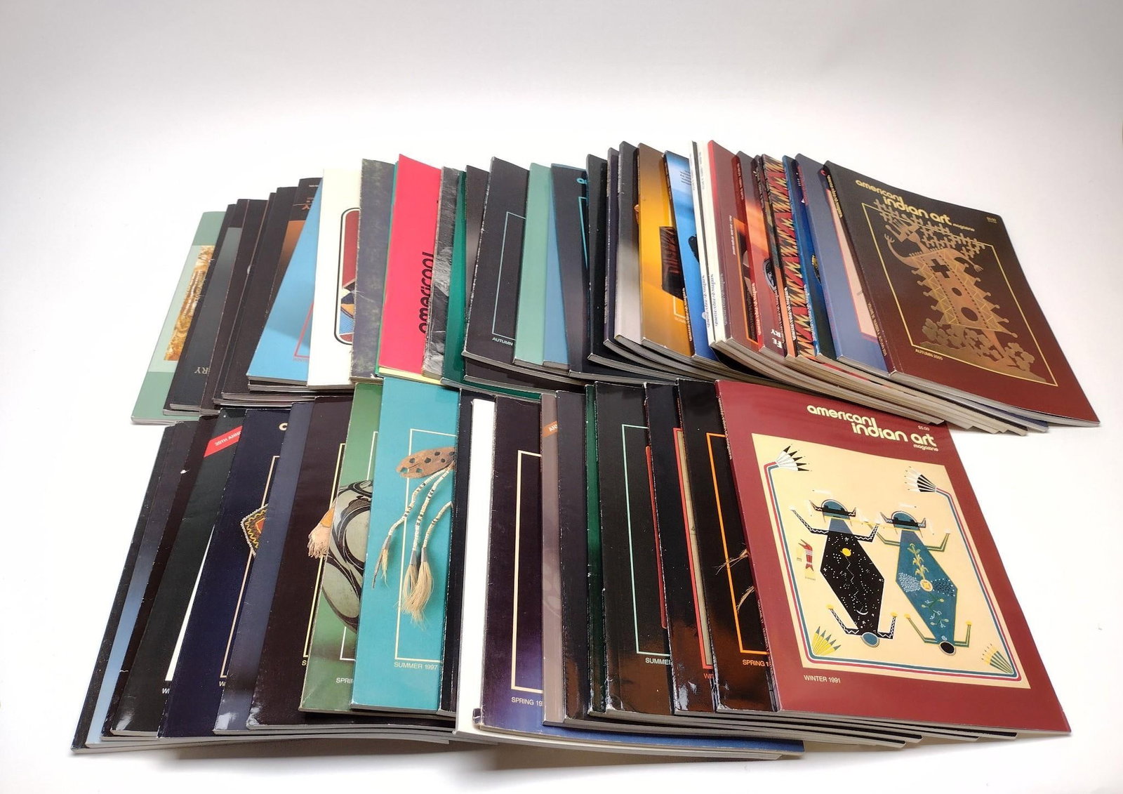 54 Issues of American Indian Art Magazines: NOT ELIGIBLE FOR IN-HOUSE SHIPPING. Includes issues from 1970s, 1980s, 1990s, and 2000s. Condition: Overall good with some creasing.