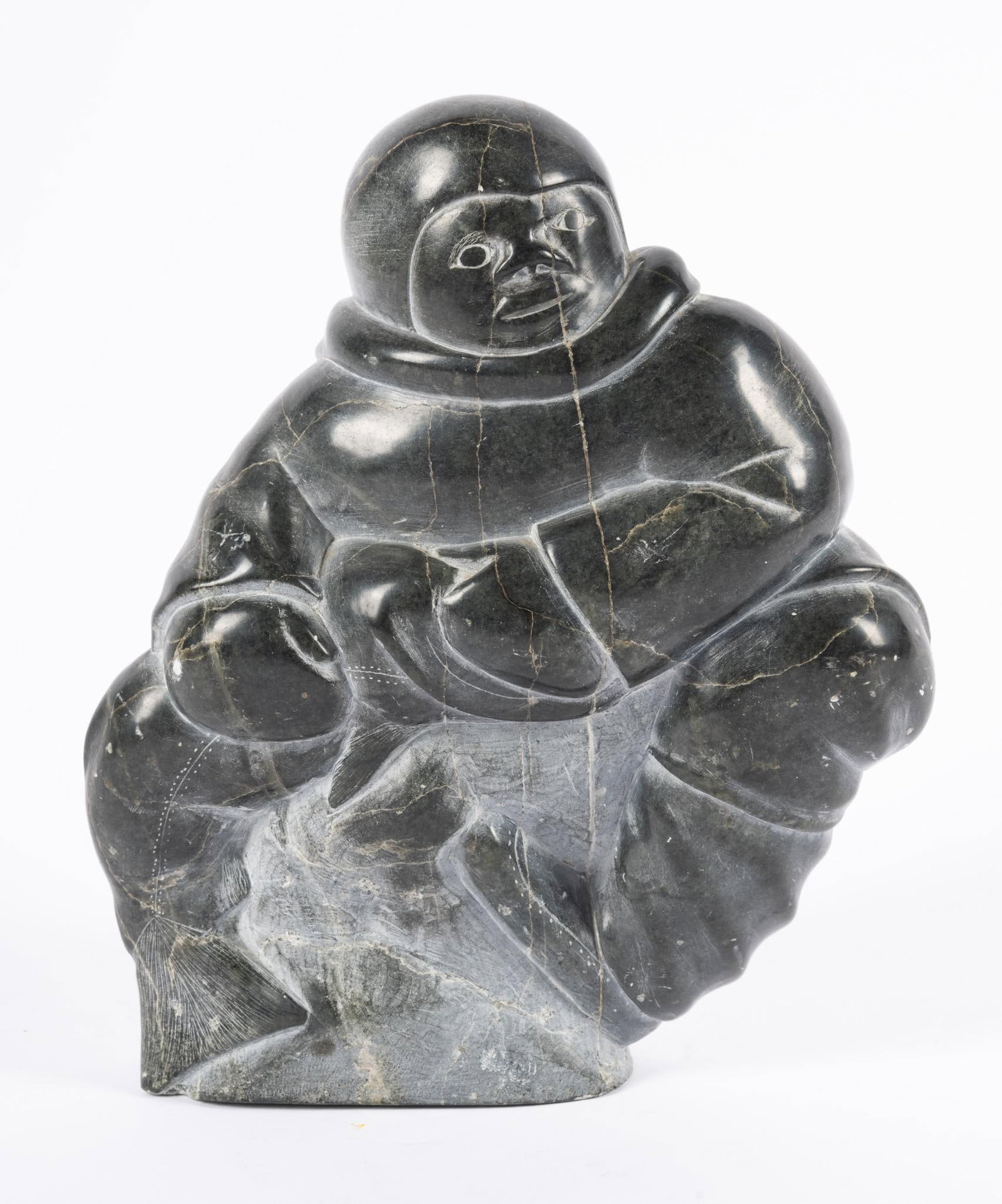 Inuit Carved Stone Sculpture by Johnny Noolookie: NOT ELIGIBLE FOR IN-HOUSE SHIPPING Alternate spelling for Noolookie is Nulukie and possibly Josie Nulukie 1931 - 1980. Signed on bottom. Hunter with fish in dark grey stone. Height of 9 1/2"