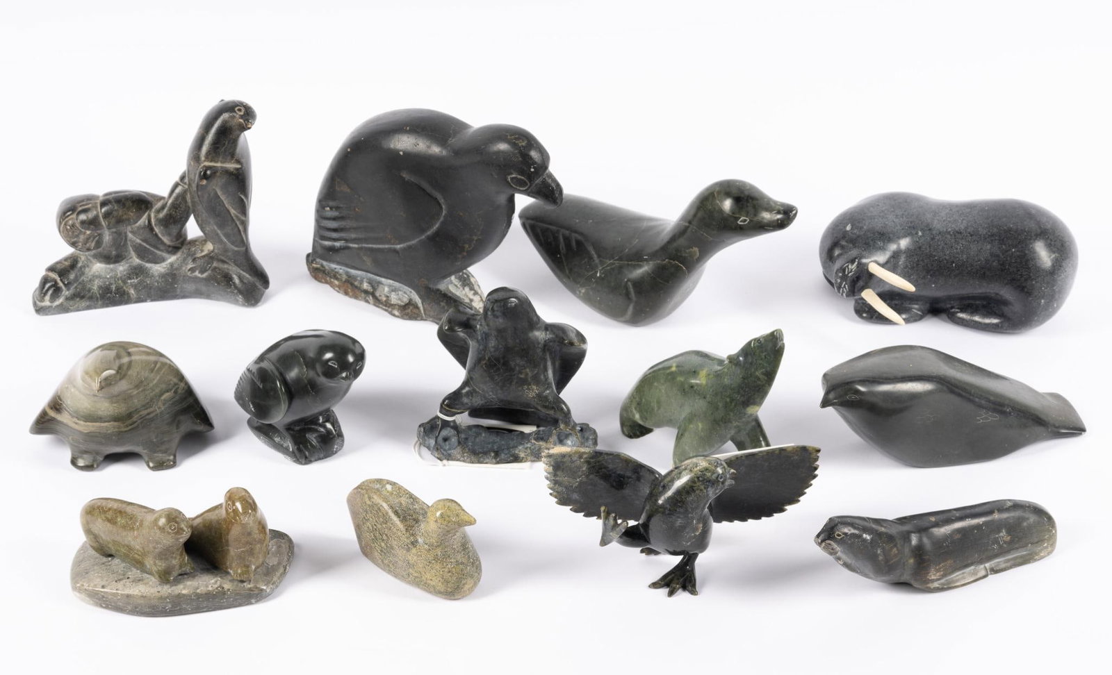13 Inuit Carved Stone Pieces: 3 1/2" to 8". Many are signed.