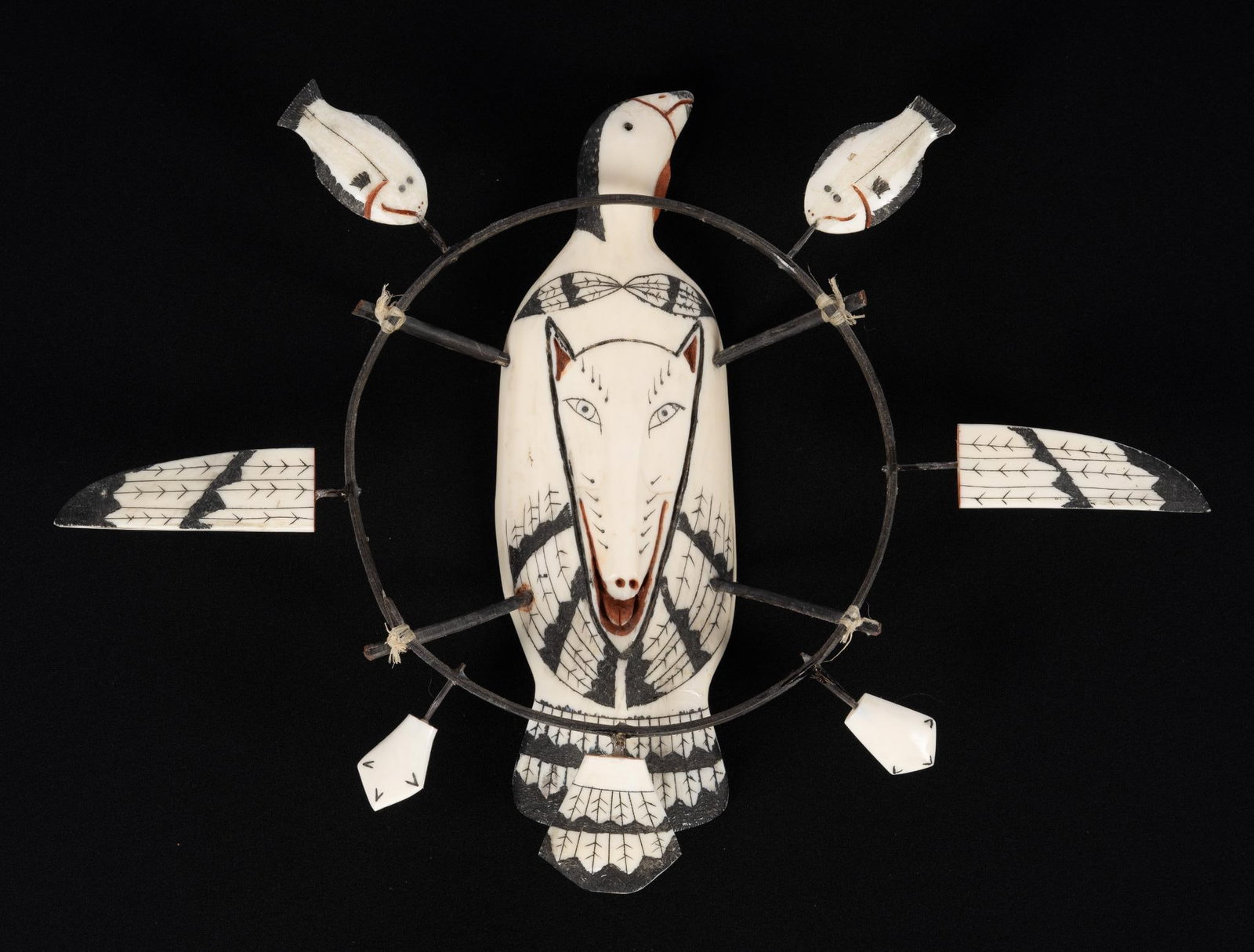 Inuit Shaman Spirit Mask: Carved bone mask with loon, wolf, and flounder. 11 1/2" wide. Signed Jim Shavings 1981.