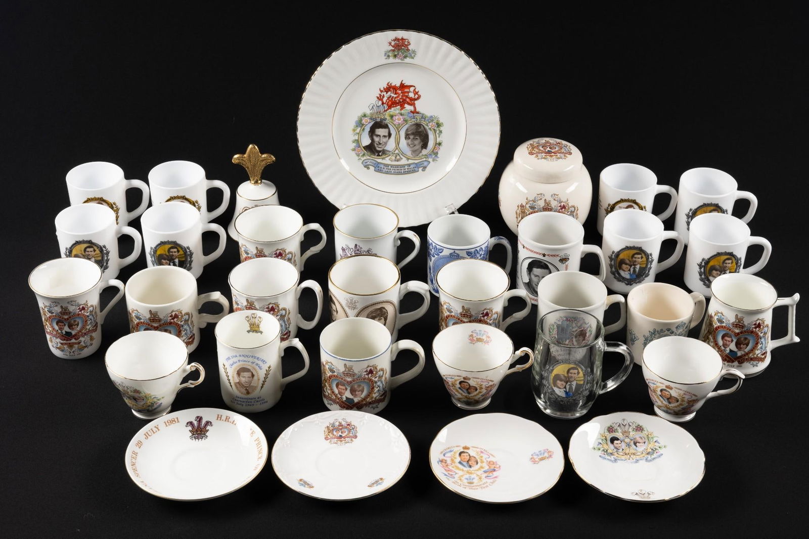 33 Charles and Diana Royal Commemoratives: Includes plates, cups, bell, jar and glassware. Drinkware 3" to 4-1/4" high.