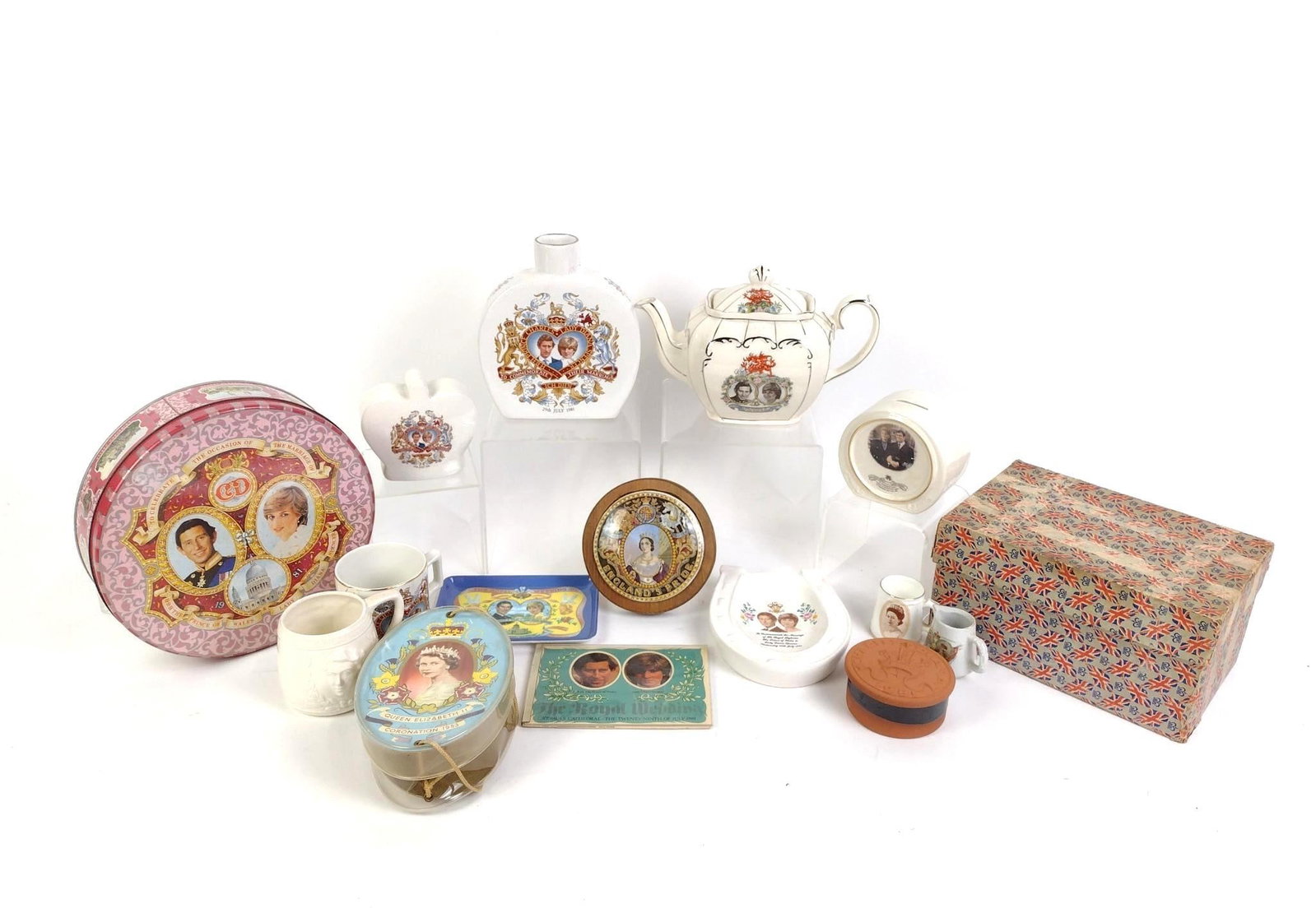 16 Pcs Royal Family Memorabilia: Includes tins, teapot, cups, and more. Cups measure 2-1/4" to 4" wide x 2" to 3" high.