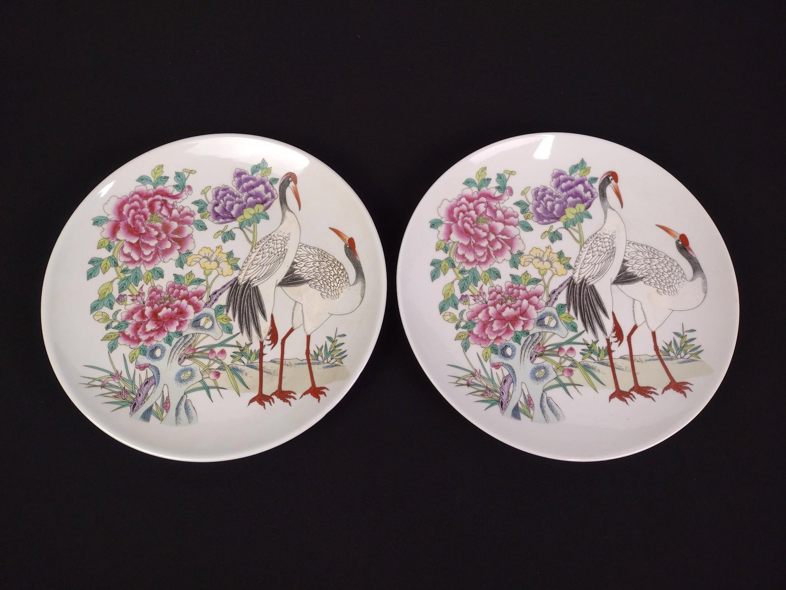 2 Gumps Asian Style Chargers in OBs: Decorated with crane. Both measure 12" diameter.