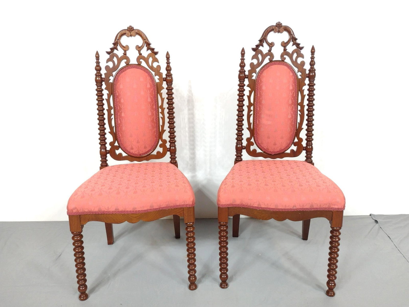 Pair of Victorian Slipper Chairs: NOT ELIGIBLE FOR IN-HOUSE SHIPPING. Two Slipper chairs with spindle front legs and back. Ornate carving. New upholstery. Refinished. Each 16-1/2" wide X 16-1/2" deep X 39" high.