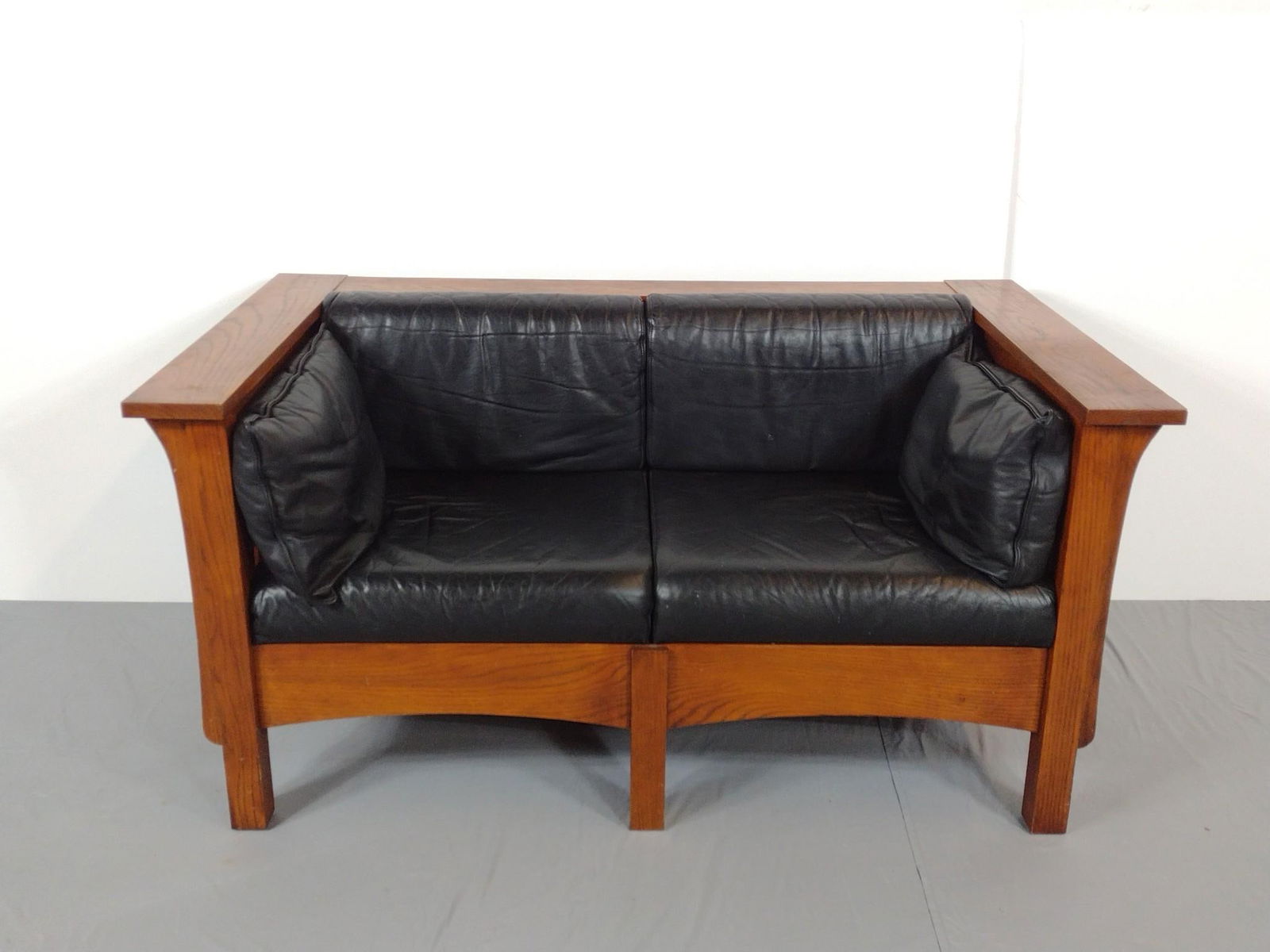 Mission Style Loveseat: NOT ELIGIBLE FOR IN-HOUSE SHIPPING. 58-1/4" wide X 34-1/2" deep X 29" high. Has some light scratches. No manufactures name found.