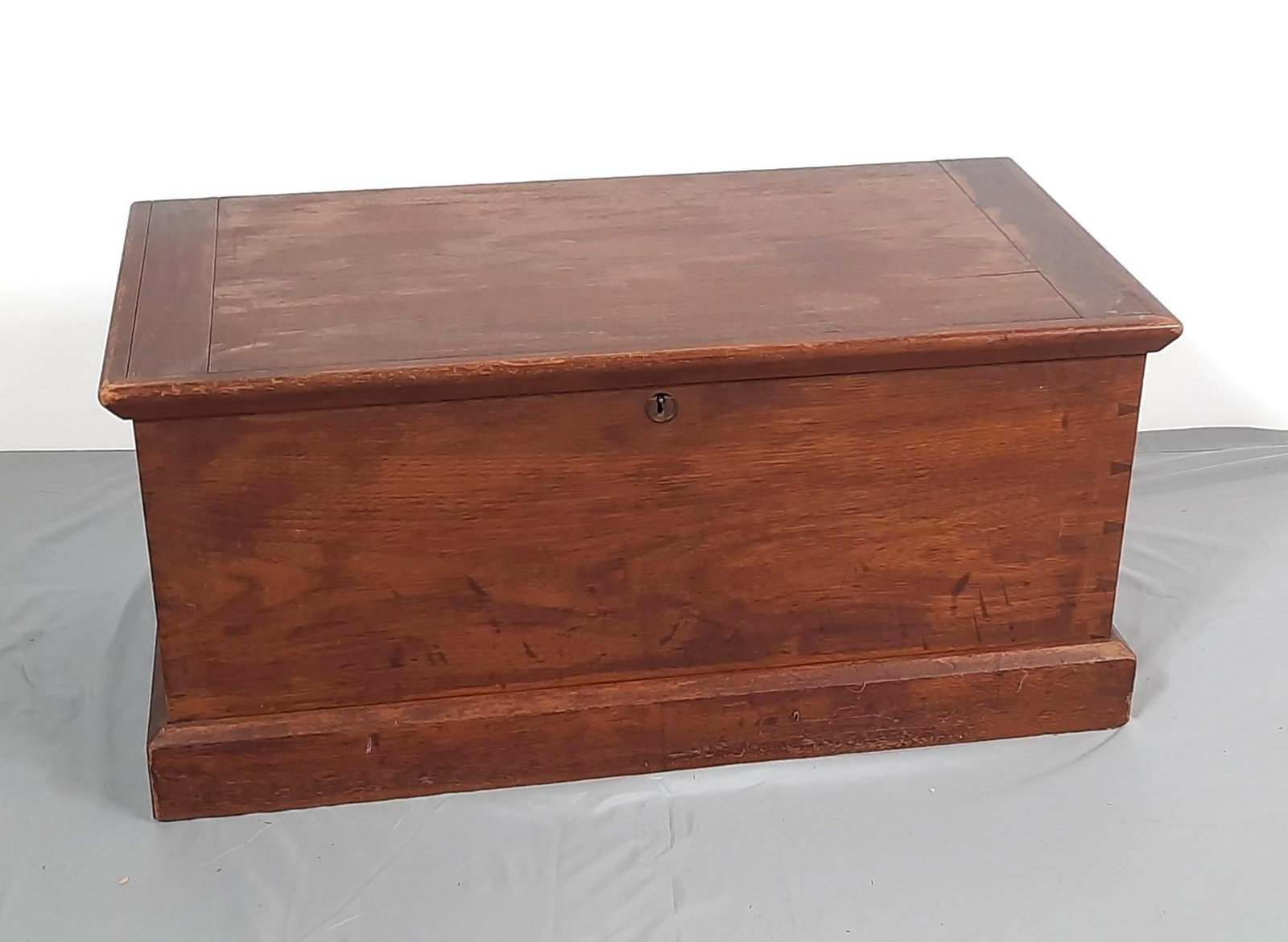 Antique Blanket Chest with Brass Handles: NOT ELIGIBLE FOR IN-HOUSE SHIPPING. 33-1/2" wide x 17" deep x 15-1/2" high. Some scratches to finish. Split to wood top.