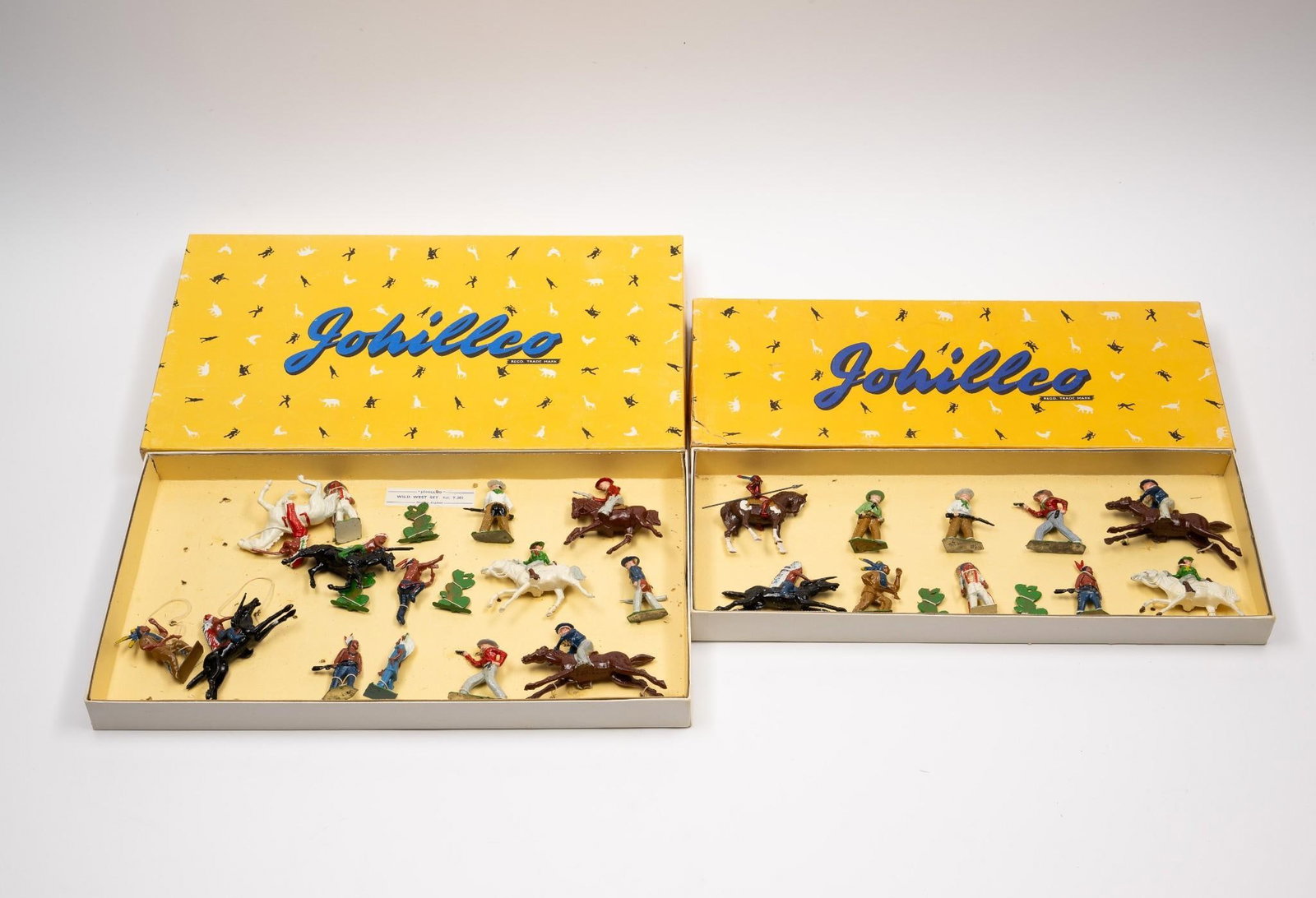 2 Boxes Johillco Tin Cowboys & Native American Figures in OBs: Figures still attached to original boxes. Boxes measure 16-3/4" wide x 1-1/2" high.