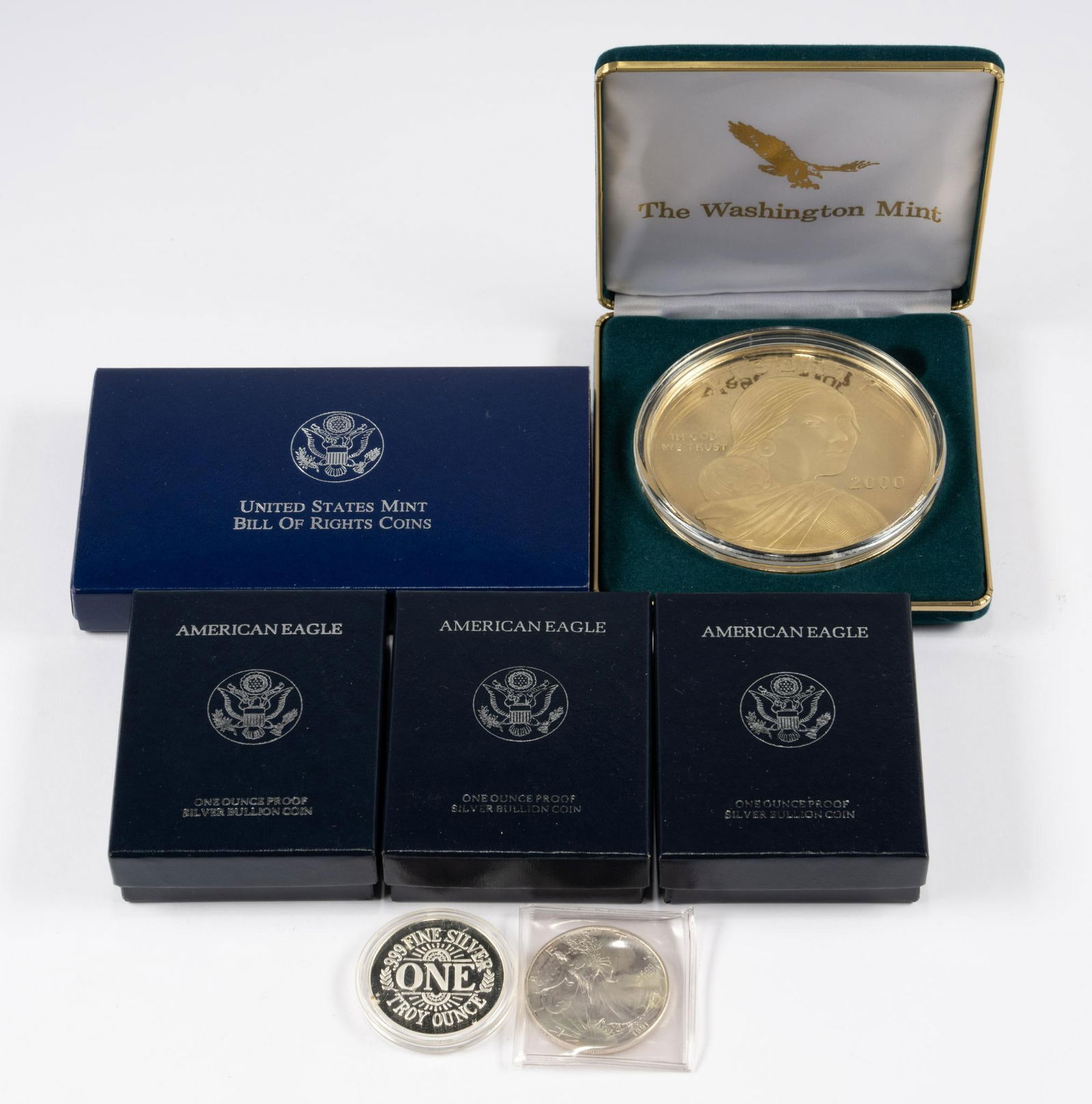Silver Coins and Silver Medallions Including American Eagles: Giant gold plated silver (vermeil) Sacagawea coin weighing 4 troy ounces pure silver, three American Eagle silver proof coins, Bill of Rights United States Mint silver coins consisting of a silver dol