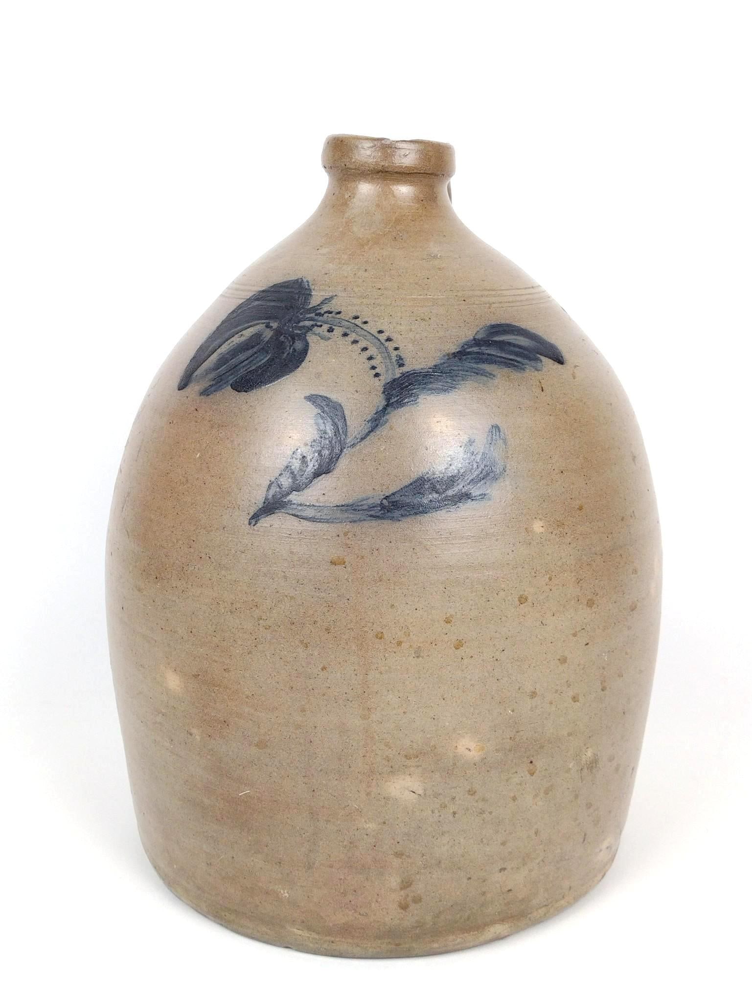 Stoneware Jug: 9-1/2" diameter X 14" high. Has some loss around mouth.