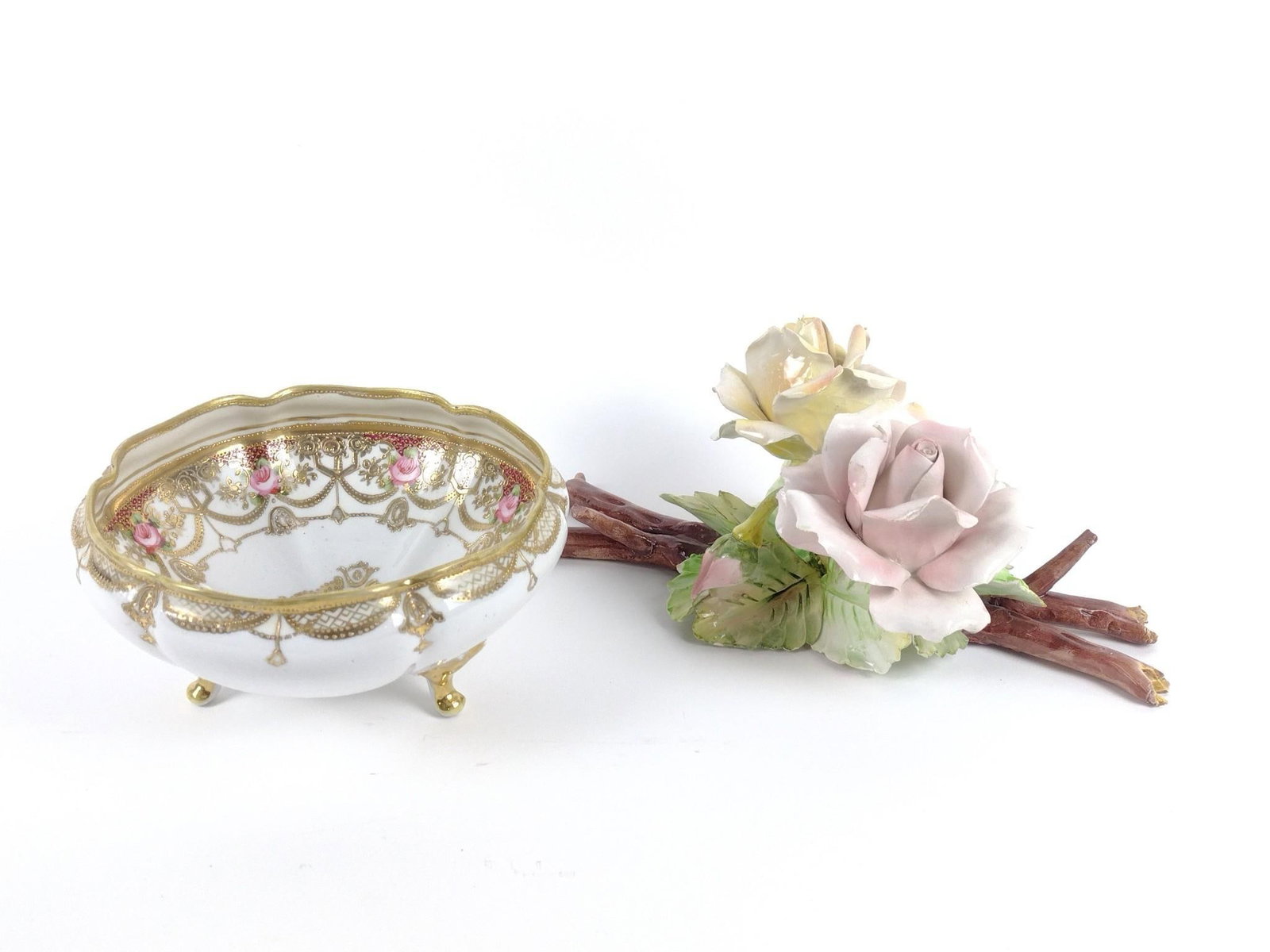Hand Painted Bowl and Ceramic Flowers: Hand painted bowl with 3 feet. Mark is worn and indecipherable. Flowers are unmarked. Flowers: 13" wide x 8-1/2" deep x 5" high. Bowl: 8" diameter x 4" high. Loss to branch on flowers.
