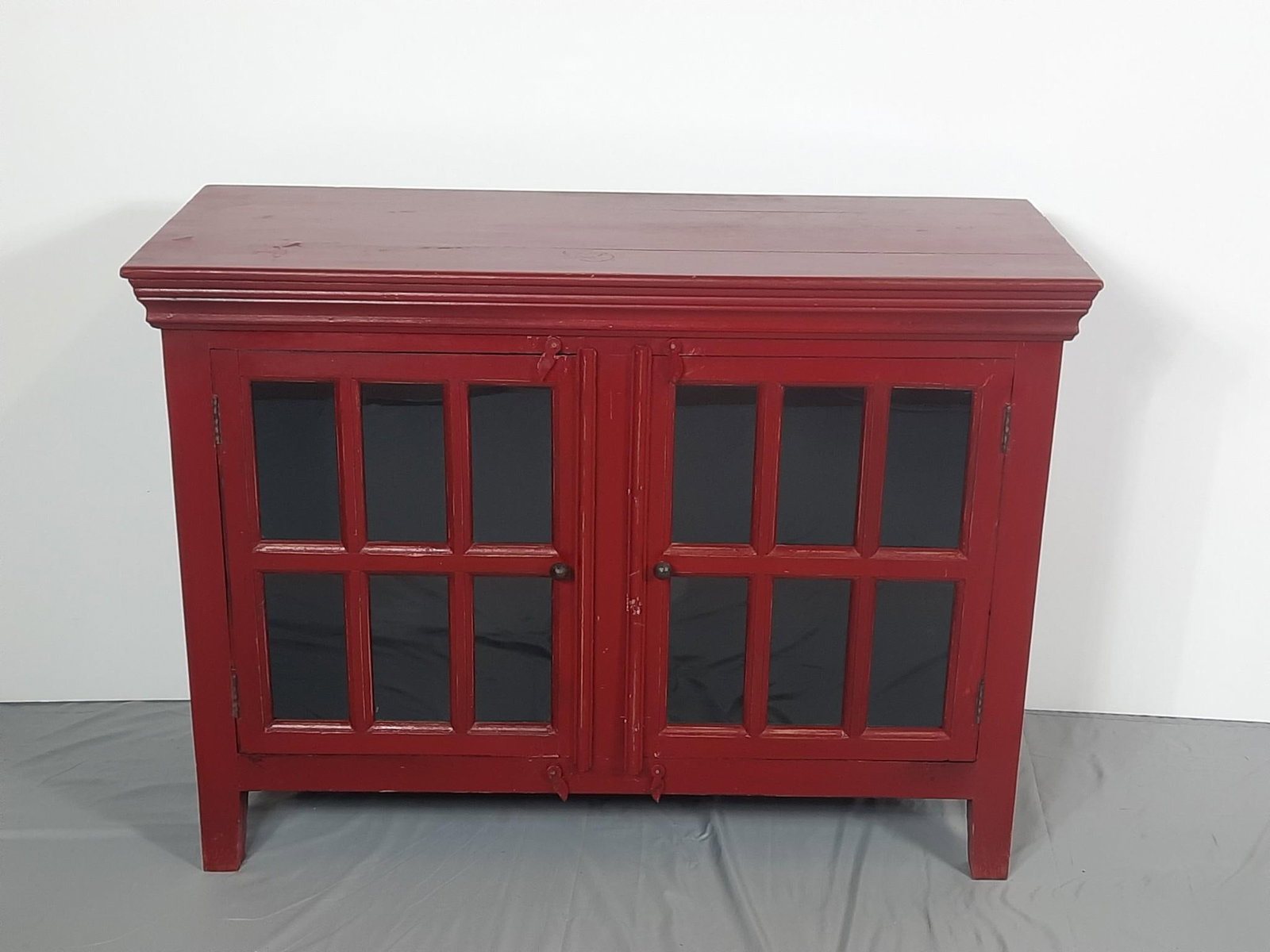 Red and Black Crate and Barrel Cabinet: NOT ELIGIBLE FOR IN-HOUSE SHIPPING. 46" wide x 18" deep x 34" high. No shelf. Some trim reattached. Some wear to paint consistent with age and use.