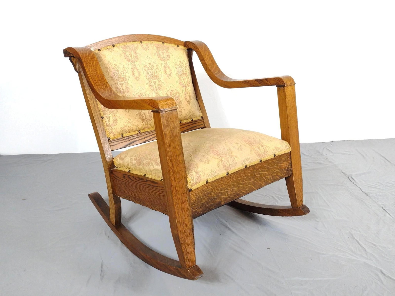 Arts & Crafts Style Rocking Chair: NOT ELIGIBLE FOR IN-HOUSE SHIPPING. 26-1/2" wide X 33" deep X 32-1/2" high. Has some discoloring to wood frame. No manufactures name found.