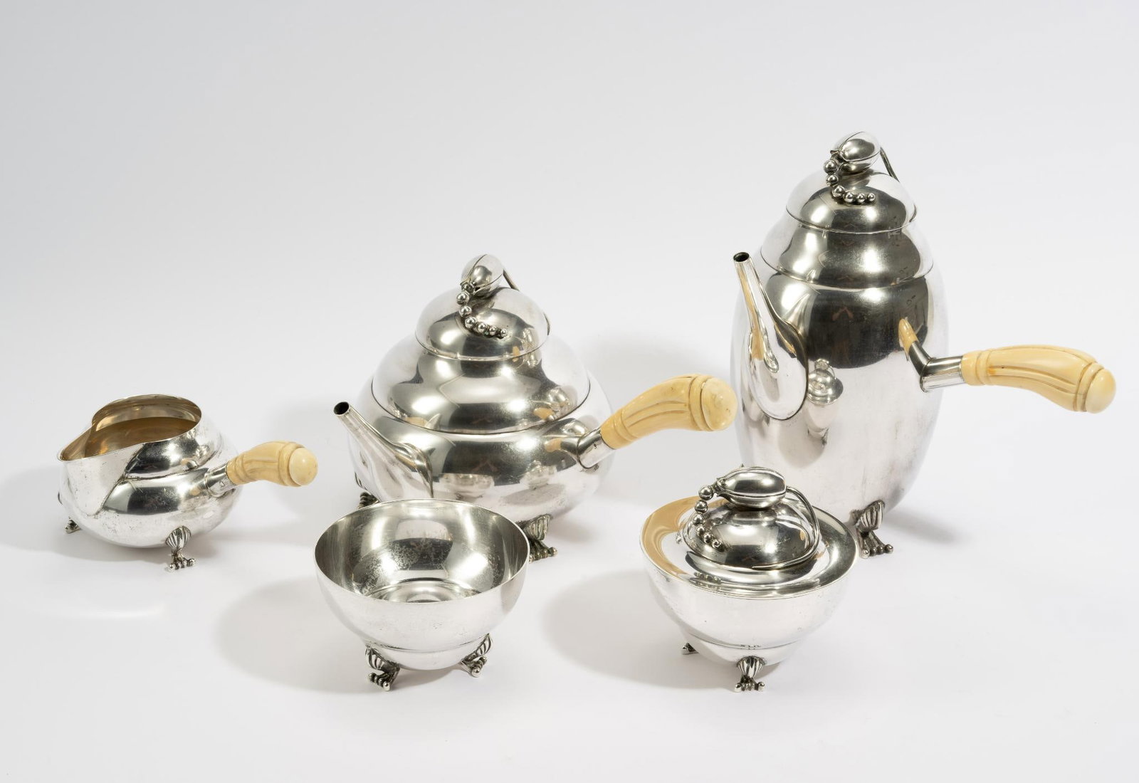 5 Pc Hamilton Sterling Silver Bone Handle Tea Service: DESCRIPTION: Includes tea pot, creamer, sugar bowl, coffee pot, and lidded dish. All marked. Creamer, tea pot, and coffee pot all have bone handles. MEASUREMENT: Tea pot measures 10" wide x 5-1/2" hig