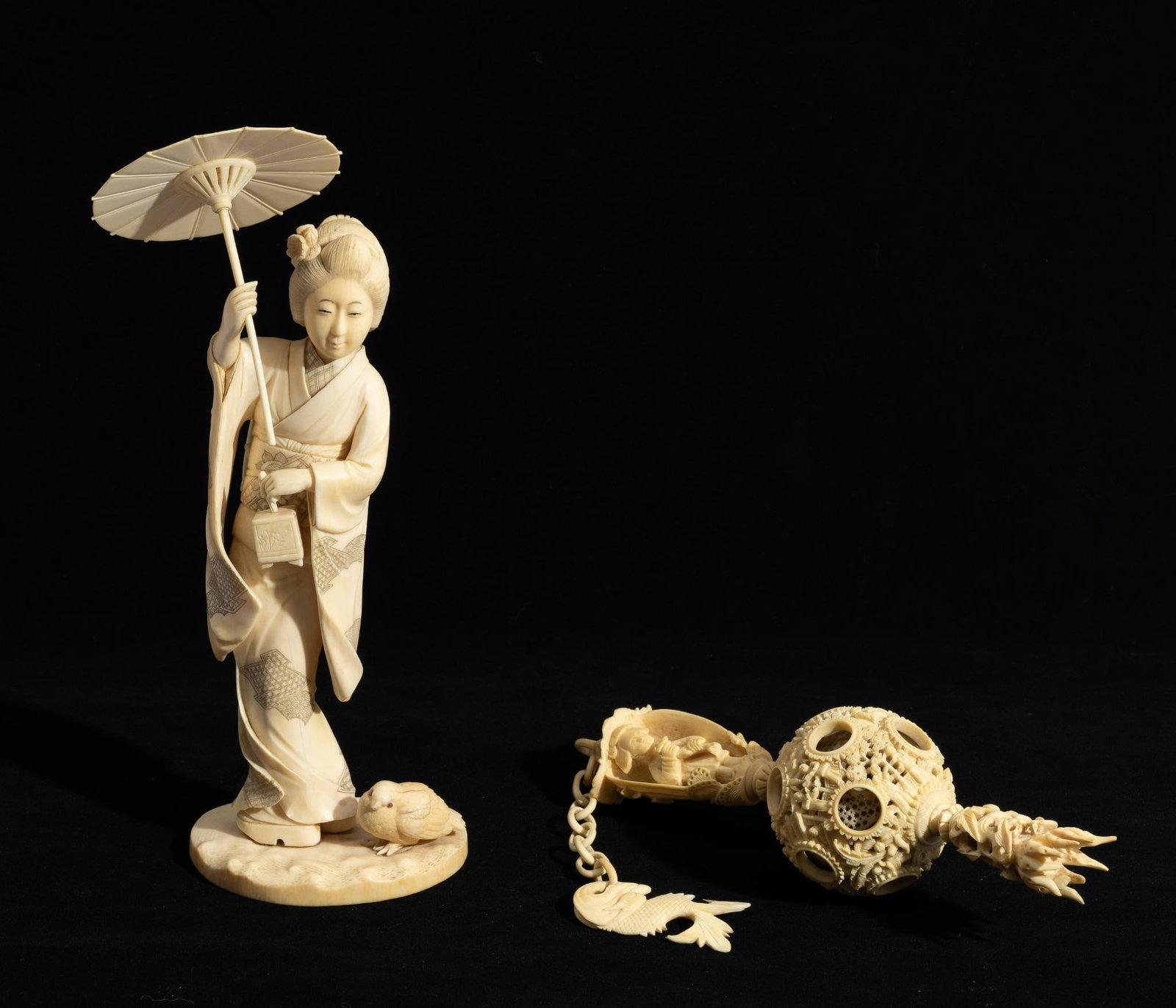 Bone Carved Puzzle Ball Figurine: DESCRIPTION: Bone carved puzzle ball with hanging chain. Bone carved female figure with umbrella. MEASUREMENT: 2-1/2" to 3-1/2" wide x 8-1/2" to 13-1/2" long. CONDITION: Umbrella on female figure is n