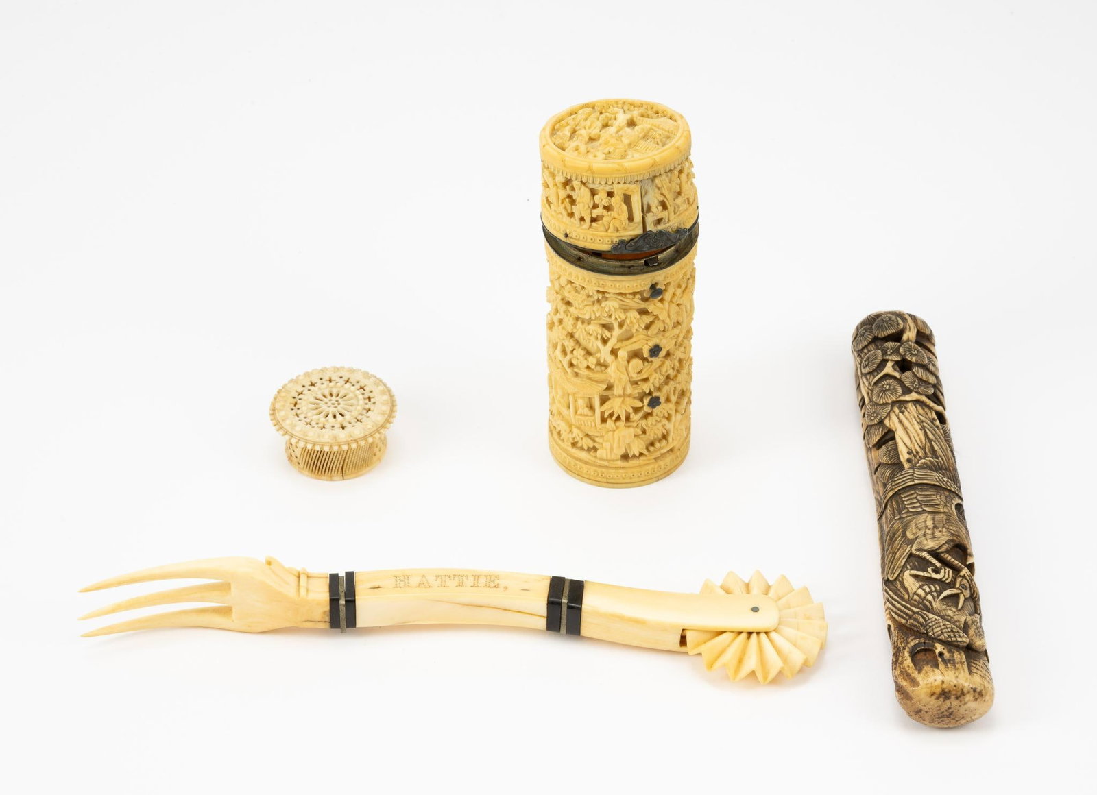 4 Bone Carved Items: DESCRIPTION: Includes two trinket boxes, intricately carved bone piece, and carved bone tool. One trinket box designed with intricate figural scenes. Smaller trinket box with cutout design. Bone piece