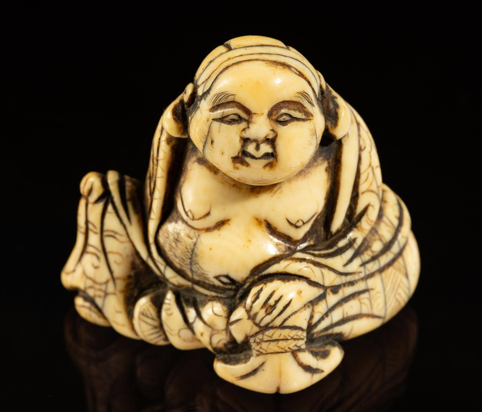 Carved Bone Katabari Netsuke: DESCRIPTION: 19th century Meiji Japanese Katabori Netsuke of Budai. Budai is a nickname given to a Chinese monk. Said to have lived around 10th century CE in the Wuyue Kingdom. Netsuke are a miniature