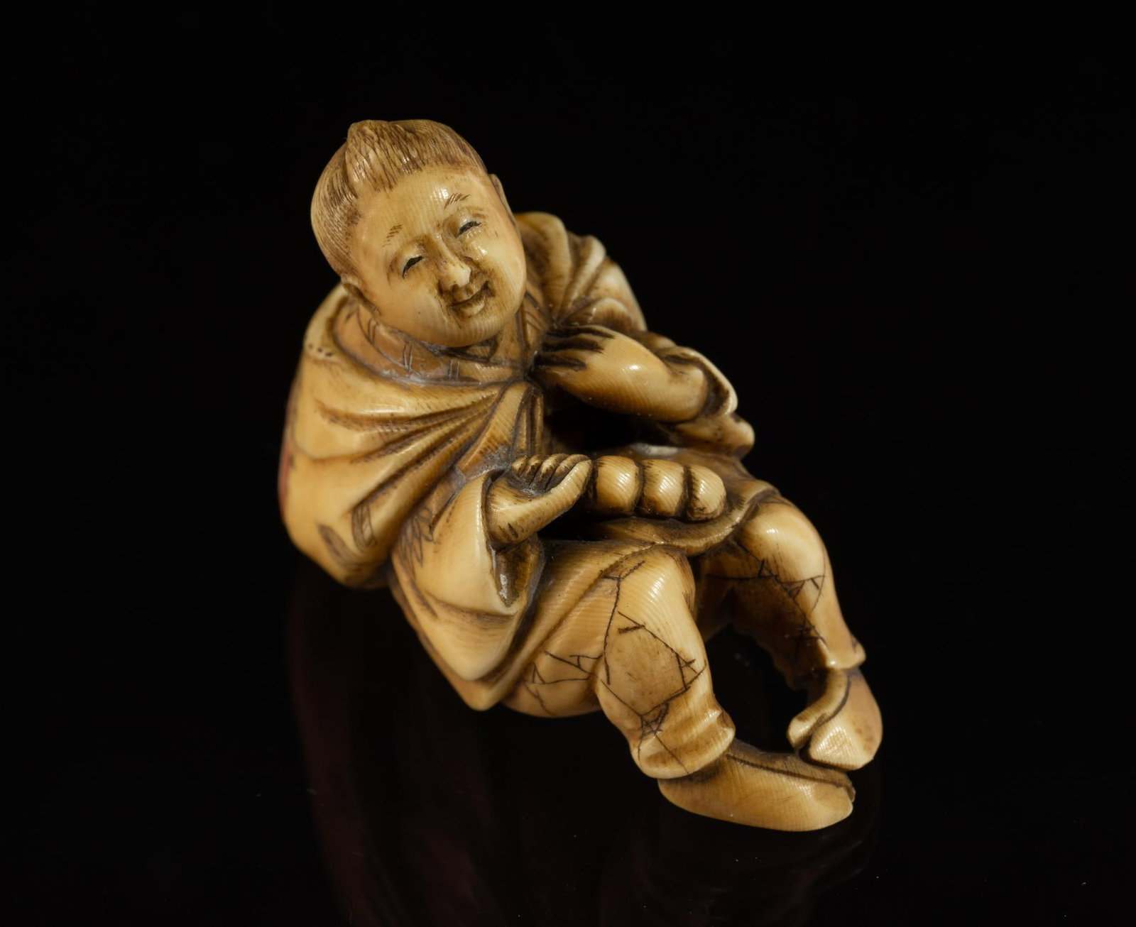 Carved Bone Katabori Netsuke: DESCRIPTION: 18th/19th century. Man sitting with sack on his back. Netsuke are miniature sculptures, originating in 17th century Japan. It was initially a simply carved button fastener on the cords of