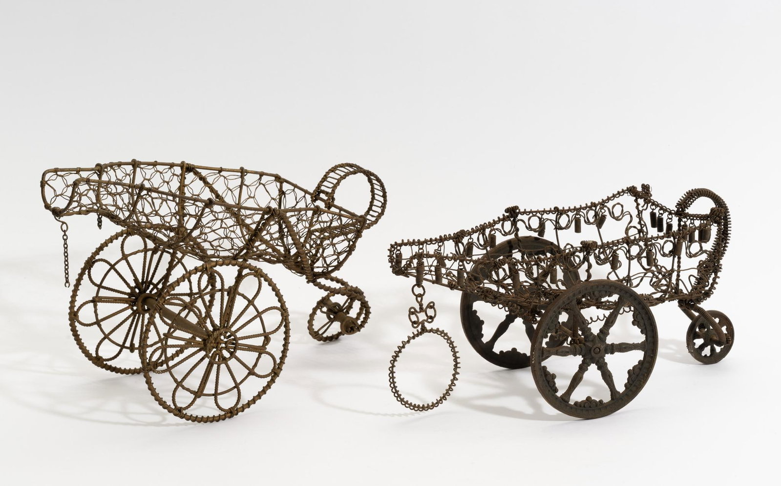 2 Early French Wire Formed Wine Trolley's: DESCRIPTION: One hand-made wire formed wine chariot with cast iron wheels, 1700's French. The piece shows surface oxidation and other signs of age. The second wine chariot is fully wire formed, except