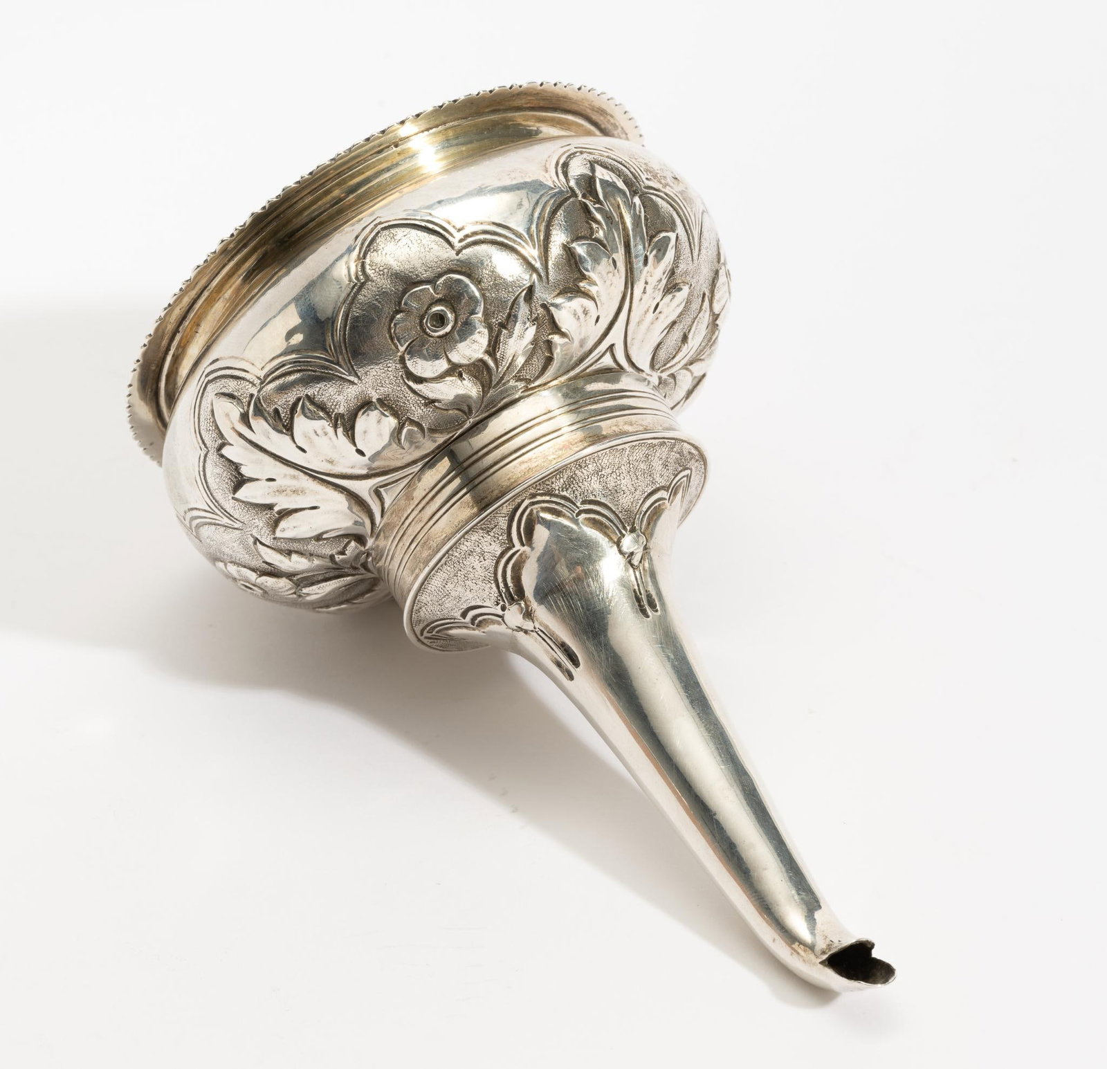 Antique English Sterling Silver Wine Funnel: DESCRIPTION: The funnel is two pieces with embossed floral detail. Both pieces are stamped CF and with London sterling stamps. MEASUREMENT: 5-1/2" high and 3.5 ozt total.