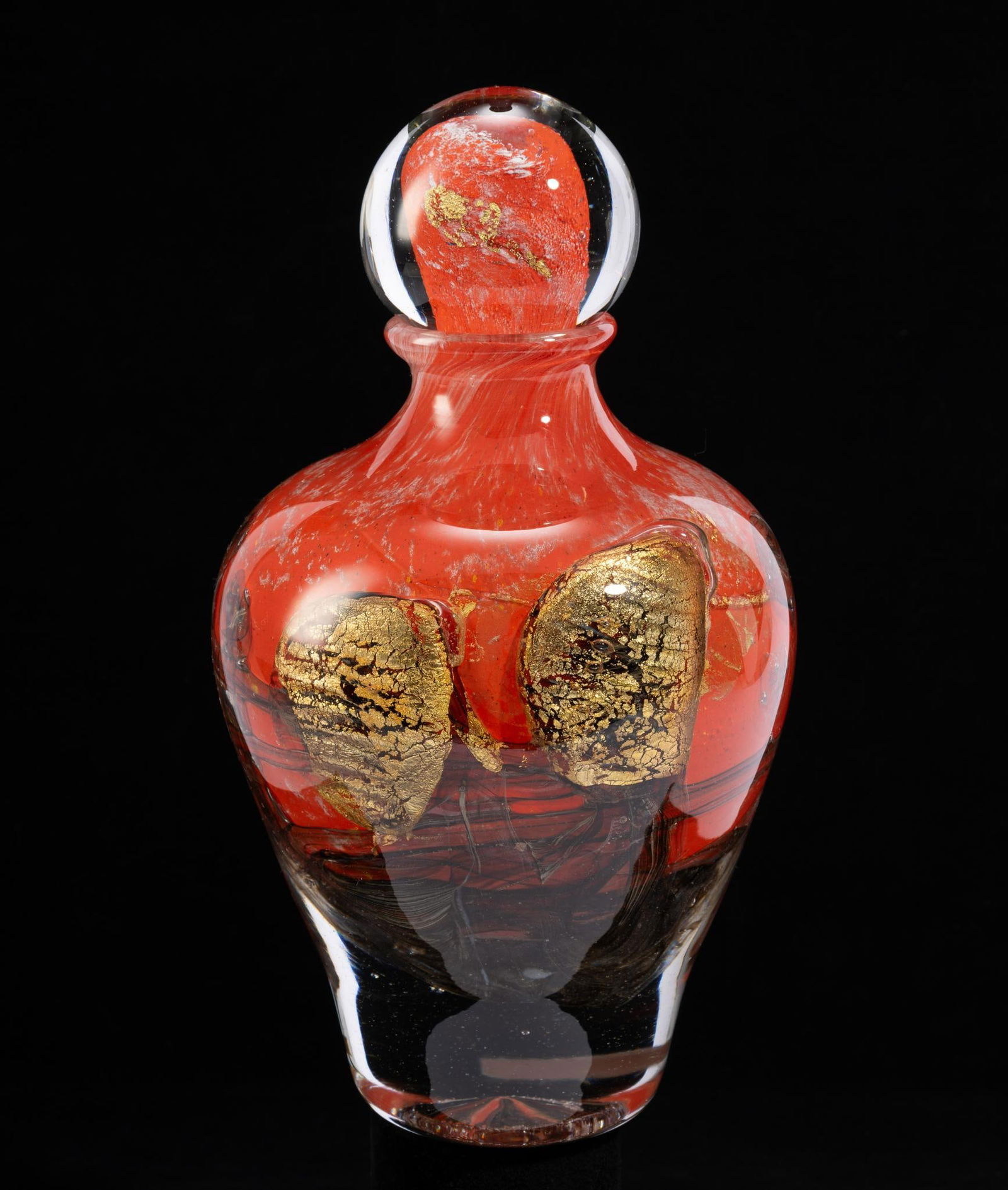 Jean-Claude Novaro (French, 1943 - 2015): DESCRIPTION: Orange decanter with gold and black design. Signed 2010. Jean Claude Novaro was a French artist considered one of the greatest glass makers of the 20th century. His art utilized Art-Deco