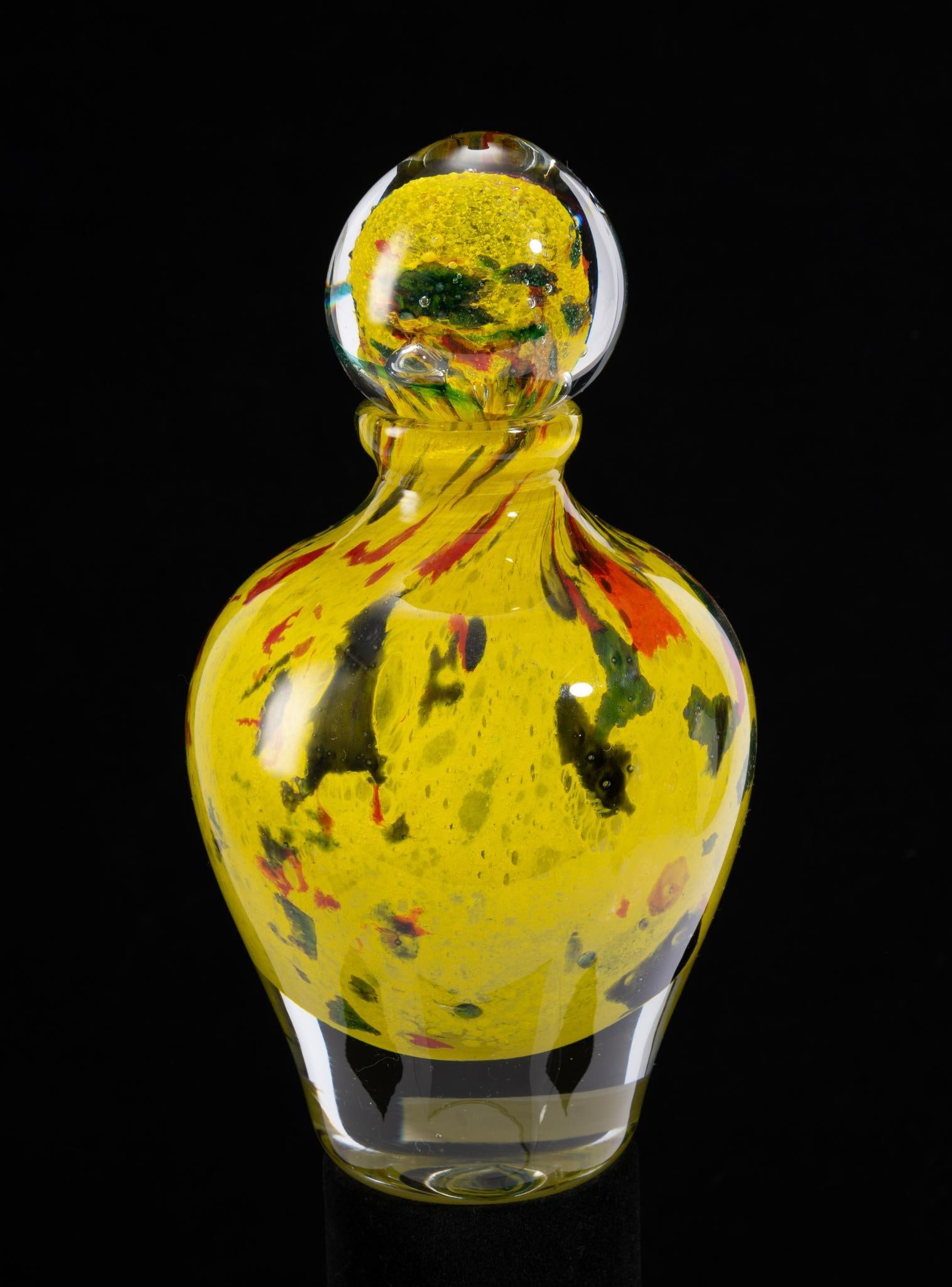 Jean-Claude Novaro (French, 1943 - 2015): DESCRIPTION: "Petite Speckled, Sunburst" glass decanter. Signed 2010. Yellow with green, orange, and blue speckles. Jean Claude Novaro was a French artist considered one of the greatest glass makers o