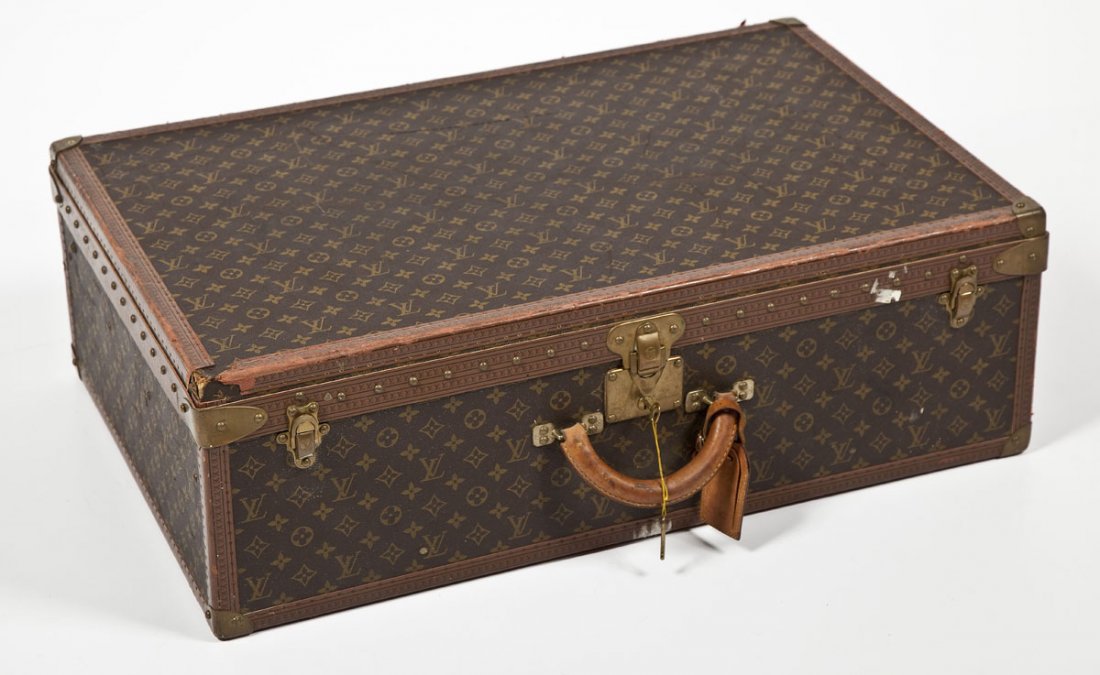 Louis Vuitton Large Hardside Suitcase: DESCRIPTION: Louis Vuitton large hardside suitcase with brass hardware including three clasps at the front with the middle having a lock and key mechanism and marked "1059105." With two keys marked "1