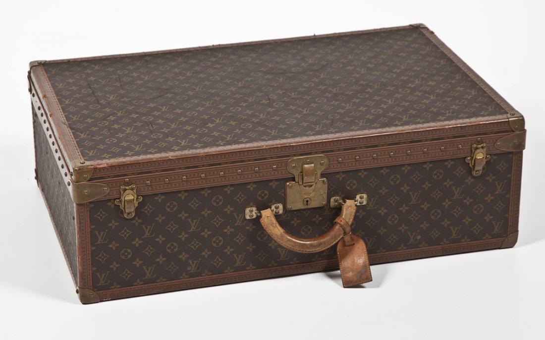 Louis Vuitton Large Hardside Suitcase: DESCRIPTION: Louis Vuitton large hardside suitcase with brass hardware including three clasps at the front with the middle having a lock and key mechanism and marked "1078234." An embossed leather bor