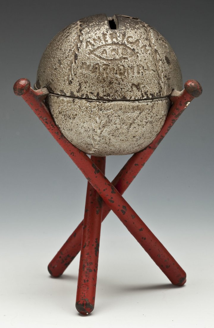 1914 Hubley Cast Iron Baseball on 3 Bats Bank: DESCRIPTION: 1914 Hubley Manufacturing Company American and National Official League baseball on three bats cast iron still bank, Lancaster Brand. Silver painted ball on three red painted bats. Listed