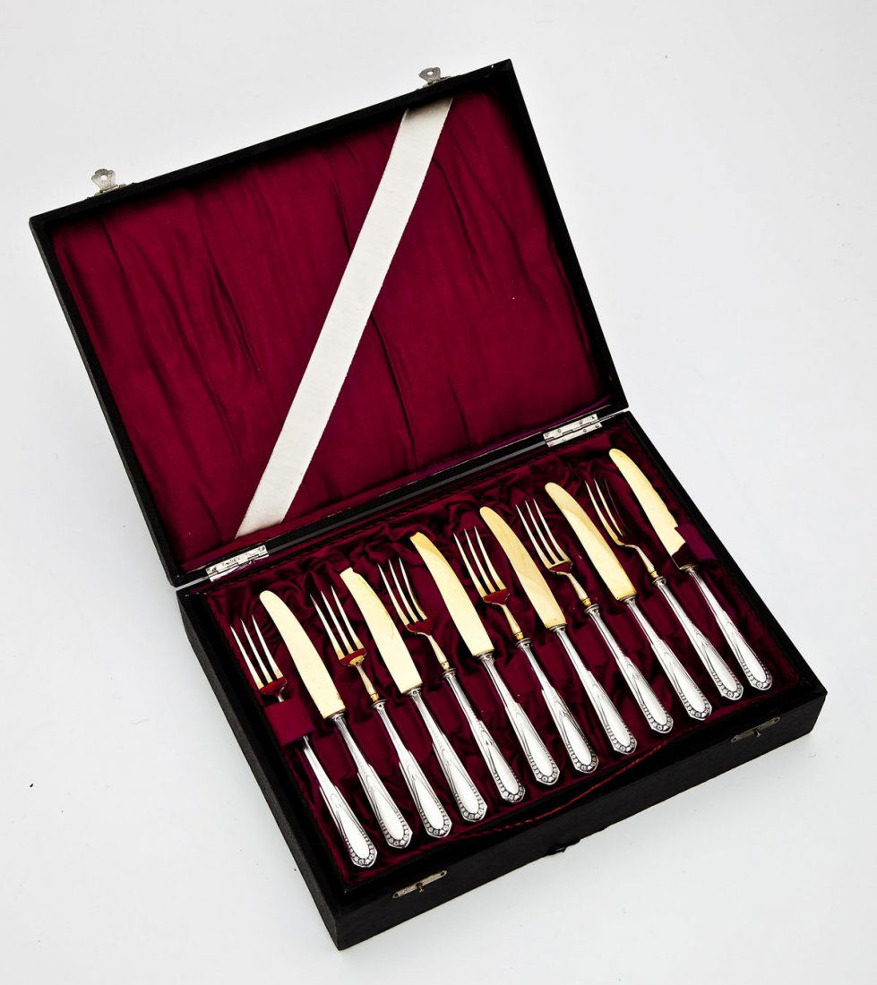Cased WMF Silverplate Fruit Set: DESCRIPTION: Cased Wurttembergische Metallwarenfabrik silverplate fruit set comprising six each of forks and knives. Each marked with WMF hallmark. Interior of case with magenta lining and a removable