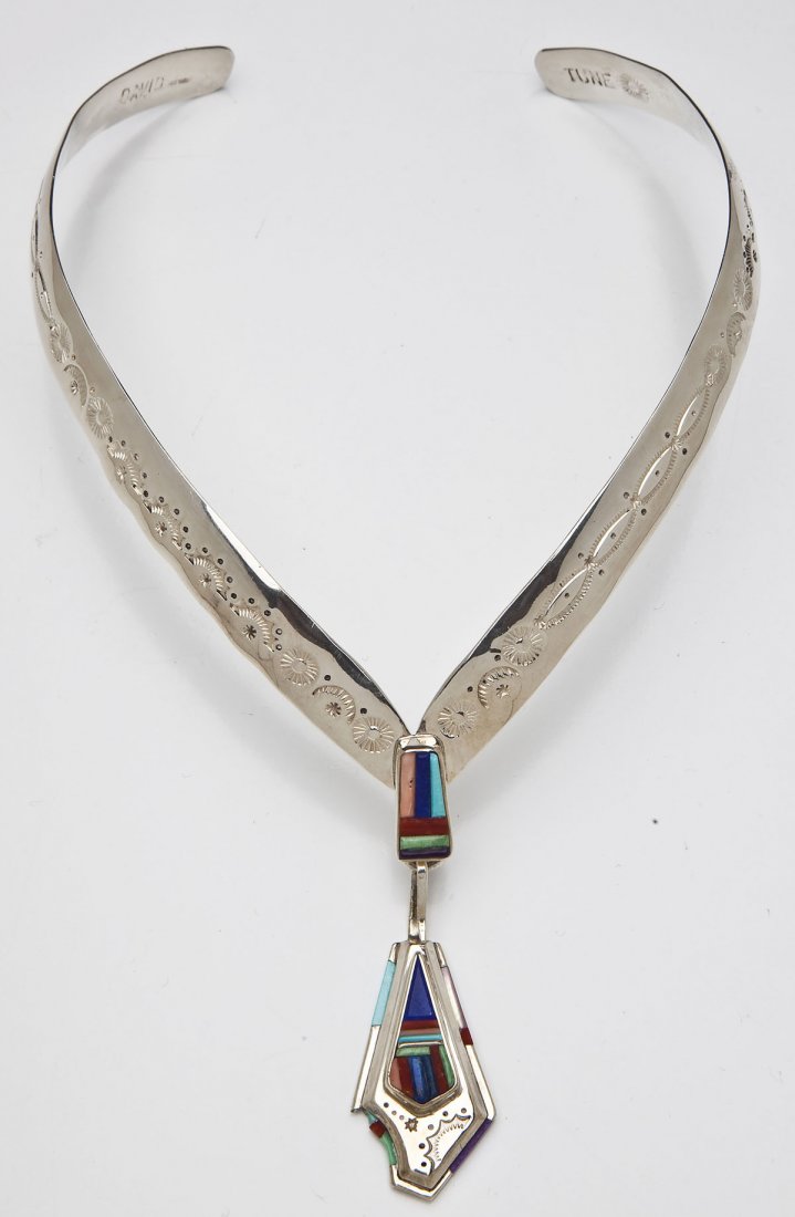 David Tune Sterling Silver Collar Necklace: DESCRIPTION: A Navajo sterling silver collar necklace by David Tune. V-shaped necklace with stamped decoration and central stone inlaid pedant from which hangs another pendant also inlaid with stones.
