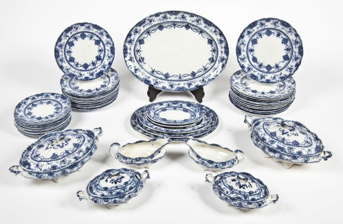 T.R. & Co. Norah Flow Blue 48 Pc Dinner Service: DESCRIPTION: T.R. & Company flow blue forty eight piece dinner service in the Norah pattern with a scroll shield and floral design. Includes: Twelve each of 10-1/4" dinner plates, 9" luncheon plates,