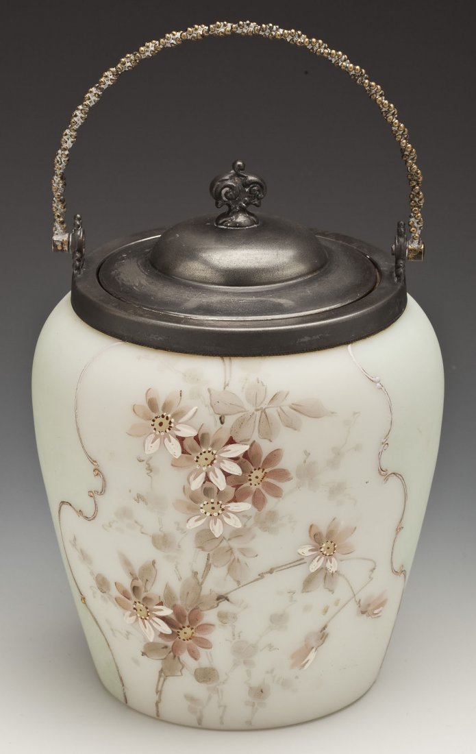 Victorian White Enameled Satin Glass Cracker Jar: DESCRIPTION: Victorian white enameled satin glass cracker jar, possibly C.F. Monroe. Handpainted with enameled mauve colored flowers and gilt decoration. With metal lid and handle. MEASUREMENTS: 9-1/2