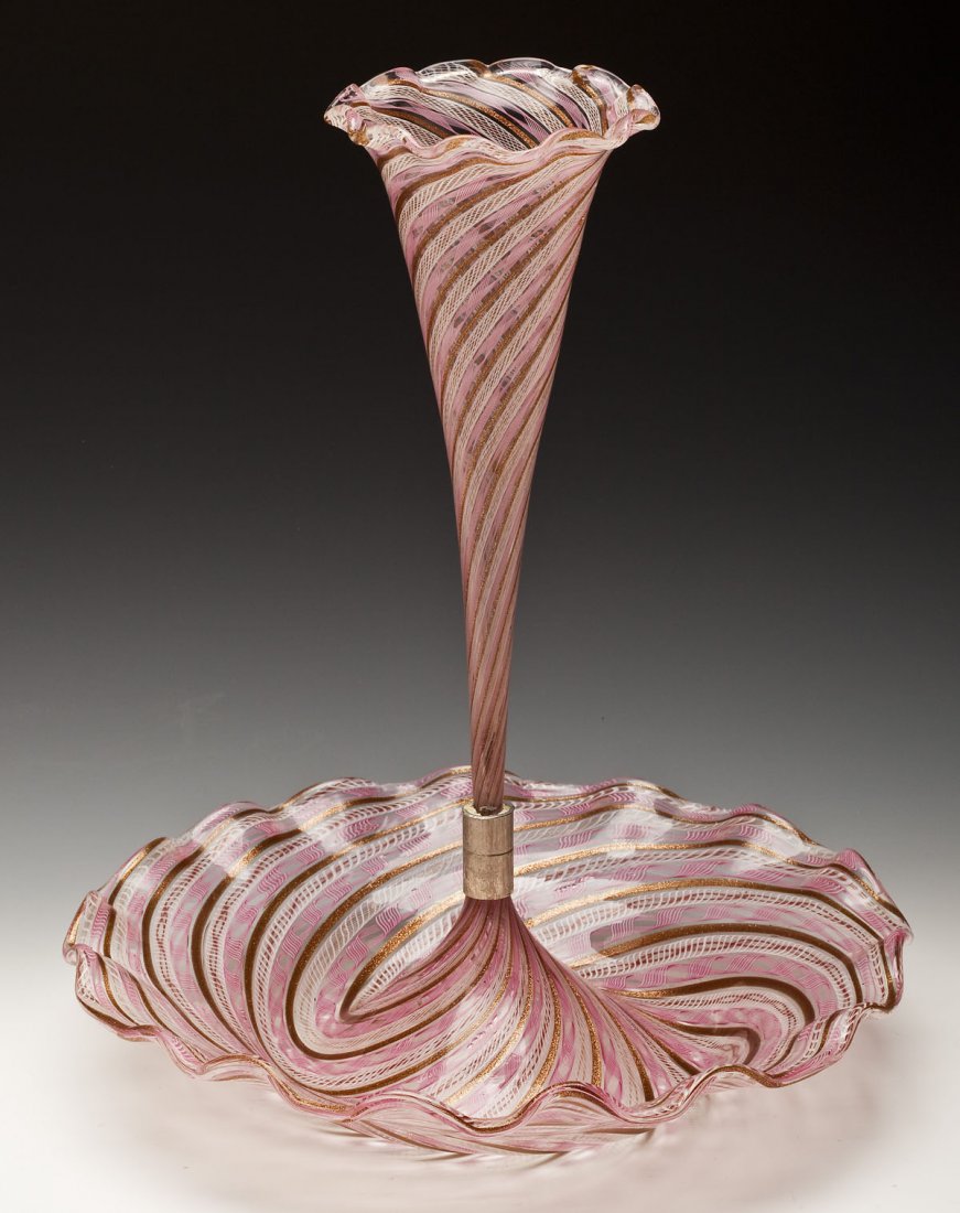 Venetian Art Glass Ribbon Swirl Epergne: DESCRIPTION: Venetian art glass epergne with a pink and copper colored ribbon swirl design throughout. With scalloped rims. MEASUREMENTS: 14-1/4" x 12". CONDITION: No defects noted.