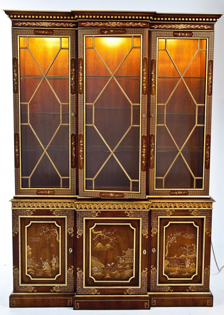 Kindel Chinese Style Breakfront: DESCRIPTION: A Kindel Chinese style two part breakfront. Top with three doors and top cornice with dentil molding. Lighted interior with adjustable shelves. Base with three doors. Decorated overall in