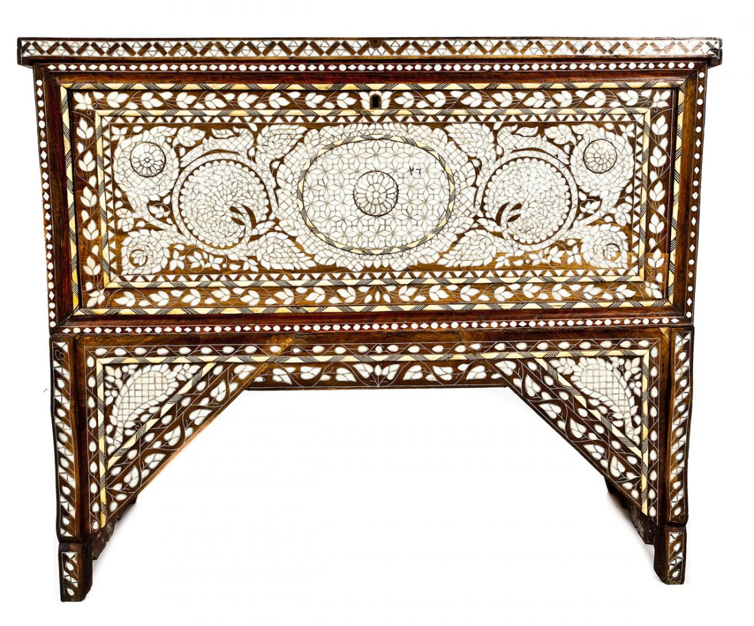 Middle Eastern High Chest: DESCRIPTION: A high chest resting upon elevated cut wooden panels and profusely inlaid with mother of pearl. Front and base heavily inlaid with floral decoration with applied inlaid medallions and bon