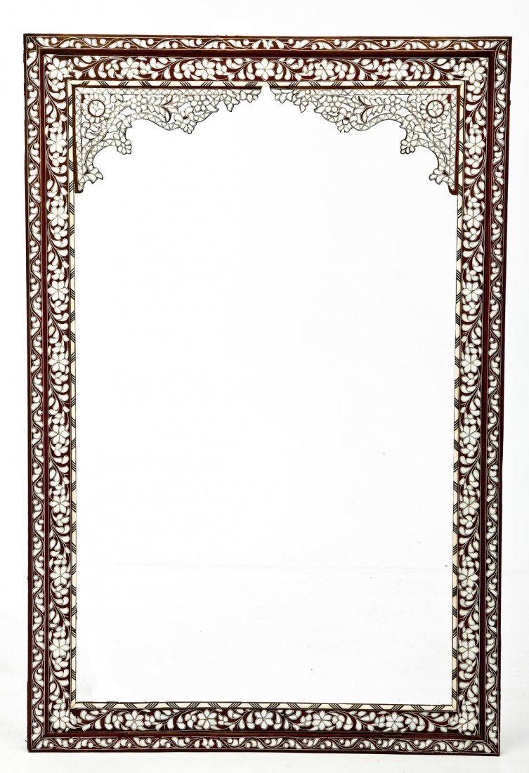 Middle Eastern Frame: DESCRIPTION: A frame profusely inlaid with mother of pearl floral decoration and having carved and reticulated top corners and applied bone trim. Middle Eastern in origin. 19th century. MEASUREMENTS: 