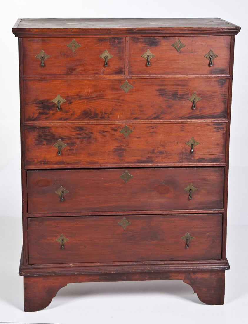 New England Red Stained Blanket Chest: DESCRIPTION: A blanket chest having lift top over two drawers. Front of chest with two small faux drawers over two large faux drawers. Bracket feet. Brass pulls and escutcheons. Red stained finish. Ne