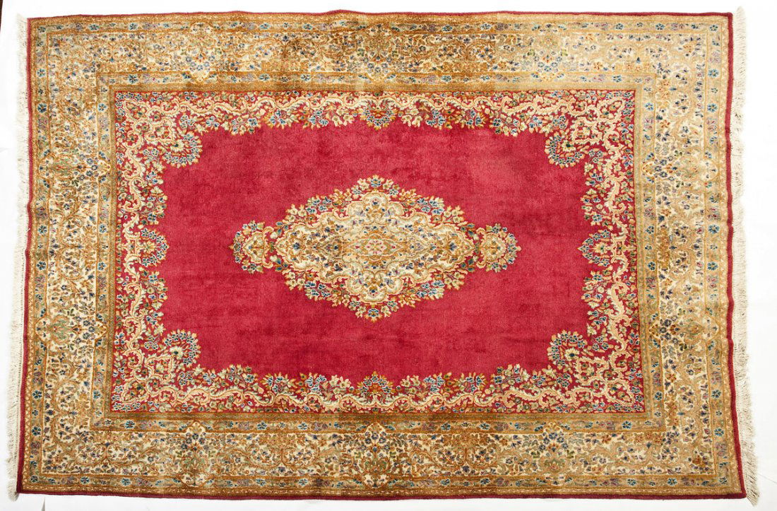 Imperial Kerman Room Size Rug: DESCRIPTION: An Imperial Kerman room size rug having typical central medallion on a red ground with wide floral border. Original label verso "Royal Rugs Imperial Kerman Made by Hand in Iran 100% Wool