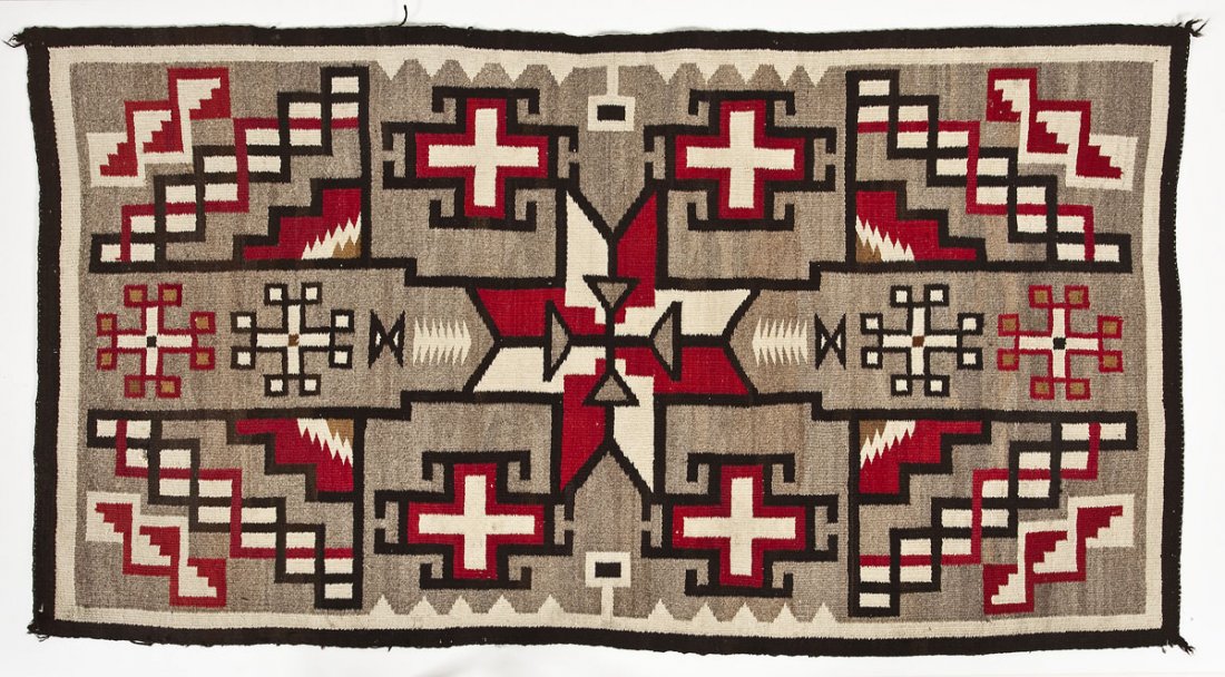 Geometric Navajo Rug: DESCRIPTION: Navajo Rug in a geometric pattern in red, white, tan, and gray with a black border and outlines. MEASUREMENTS: 6' 9-1/2" x 3' 8-1/2". CONDITION: Small 1" hole near corner with some minor 