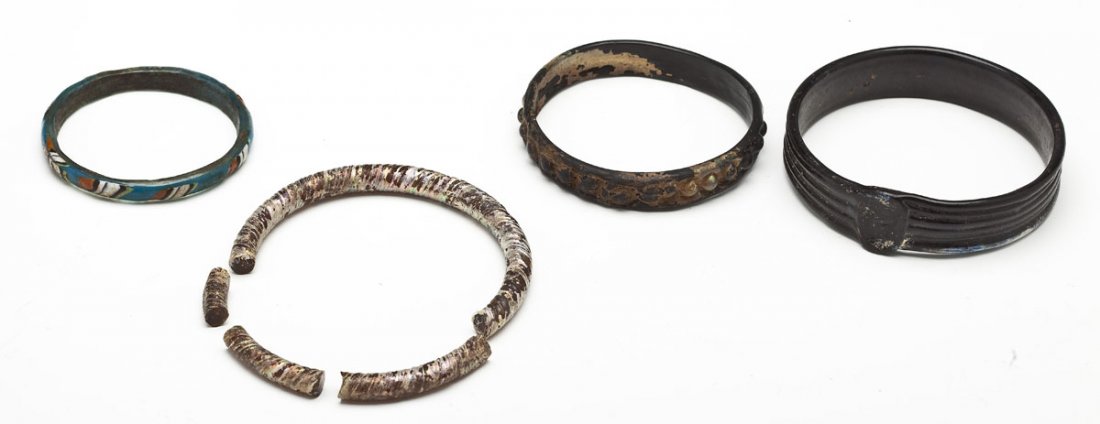 4 Roman Glass Bracelets: DESCRIPTION: A group of four ancient Roman glass bracelets or armlets. Includes: 1) Blue with black, white and orange striped panels. 2-1/2" diameter. 2) Black and gold iridescent with beaded relief. 