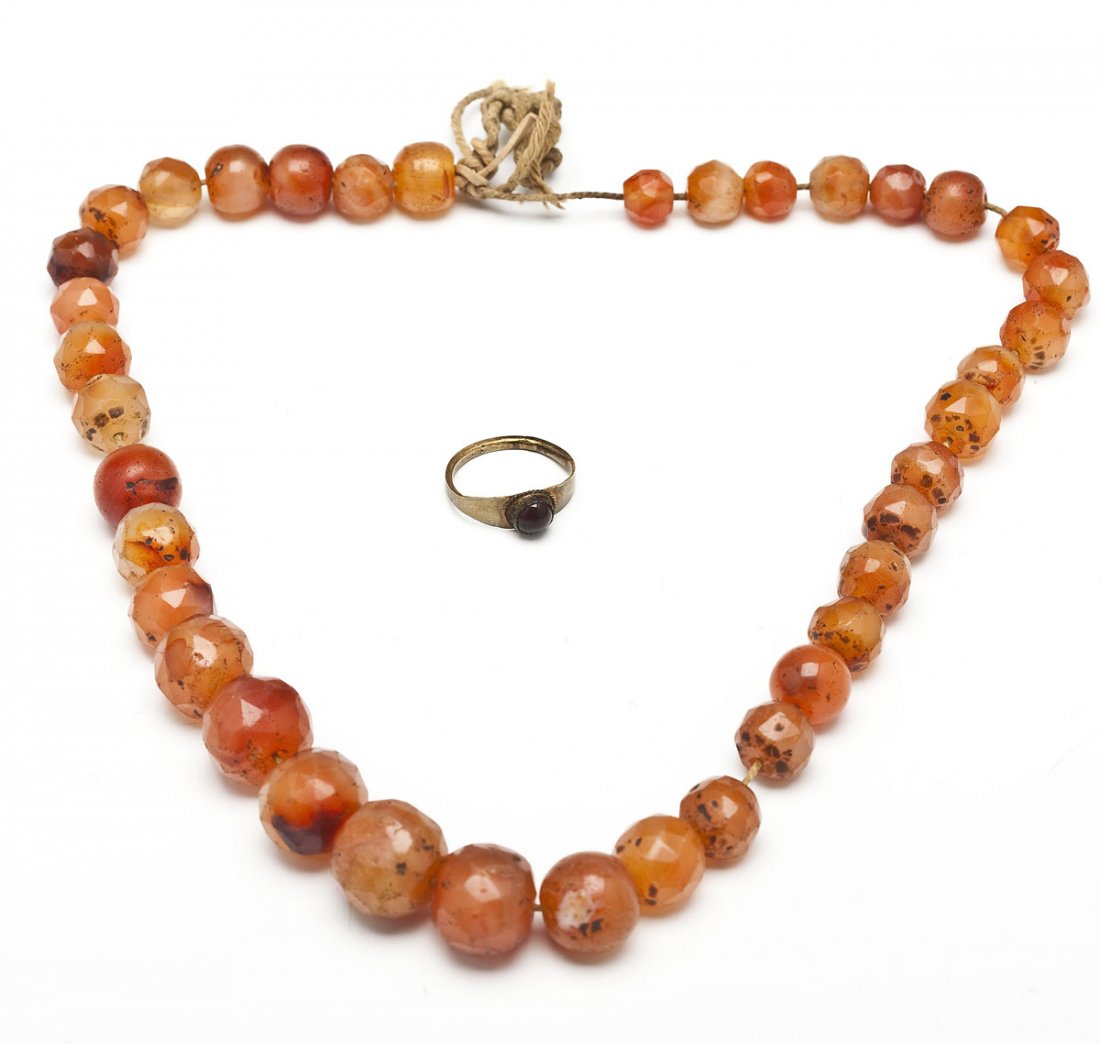 Ancient Roman Carnelian Beads & Bronze Ring: DESCRIPTION: Two pieces of ancient Roman jewelry. Includes: 1) Carnelian graduated beads, some faceted and some round, threaded on string. 2) Bronze ring with inlaid brown stone cabochon. Circa 100 to